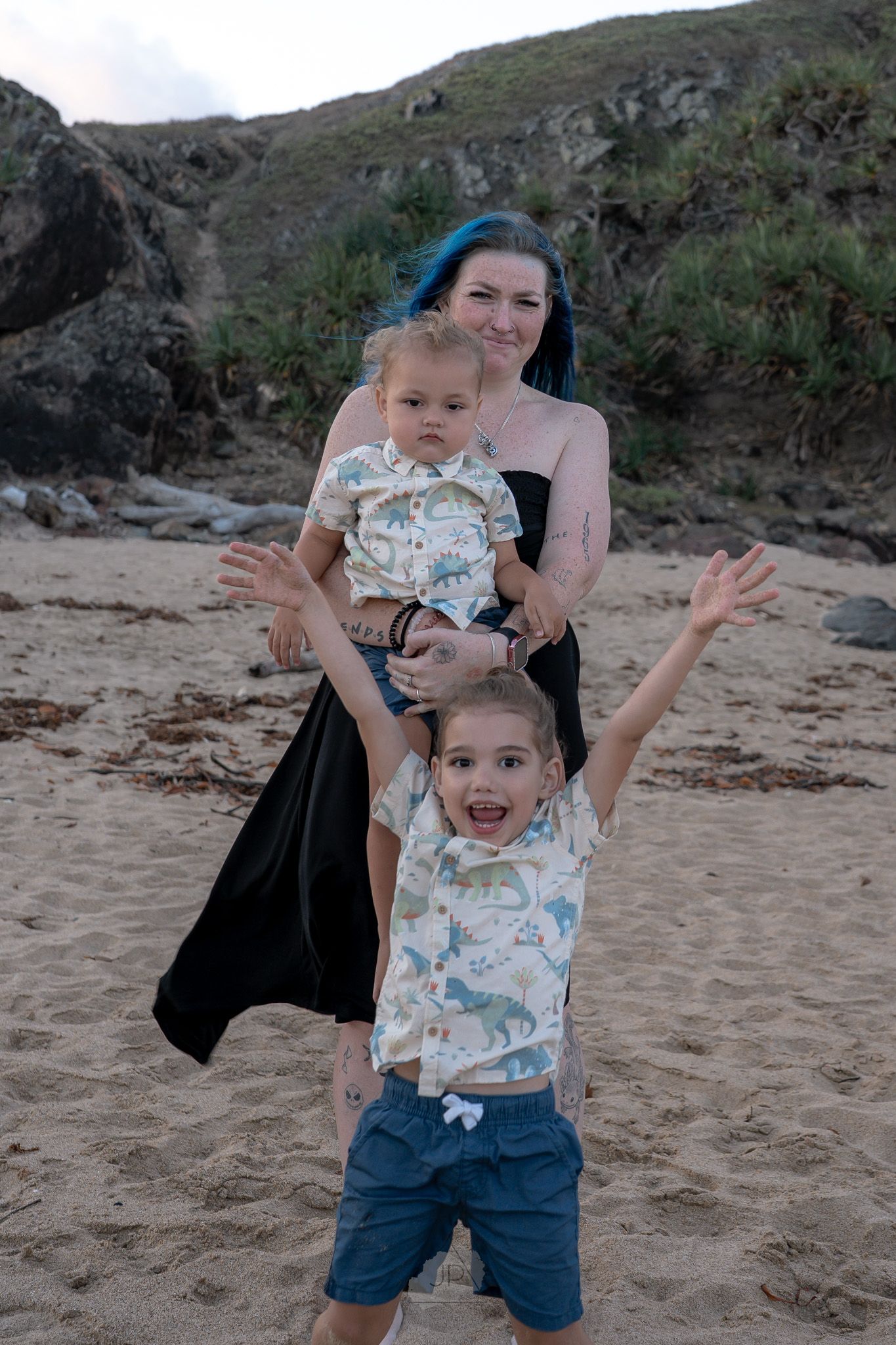 A series of playful moments captured on a sandy beach with cliffs in the background during golden hour.