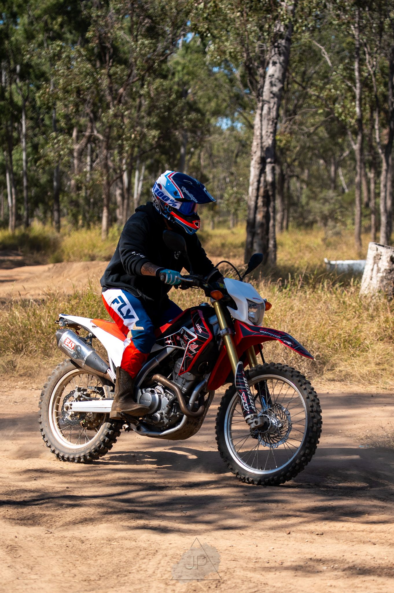 Series of off-road dirt bike shots showing a motorcycle rider navigating a winding trail through wooded terrain.
