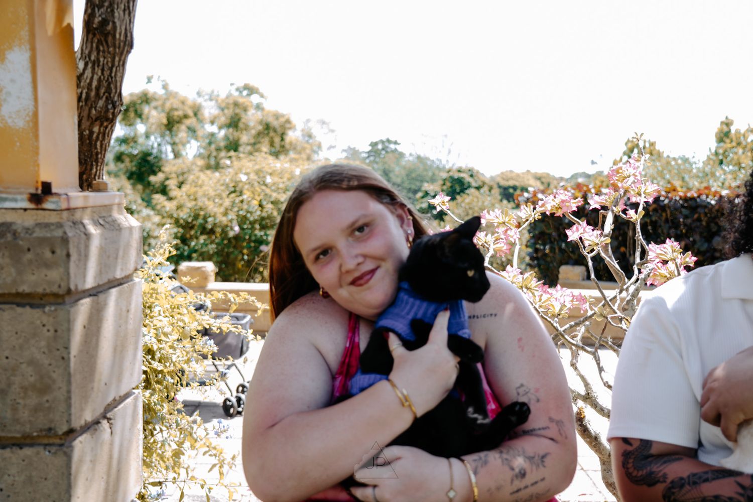 People holding and cuddling with black cats in a series of heartwarming adoption photos.