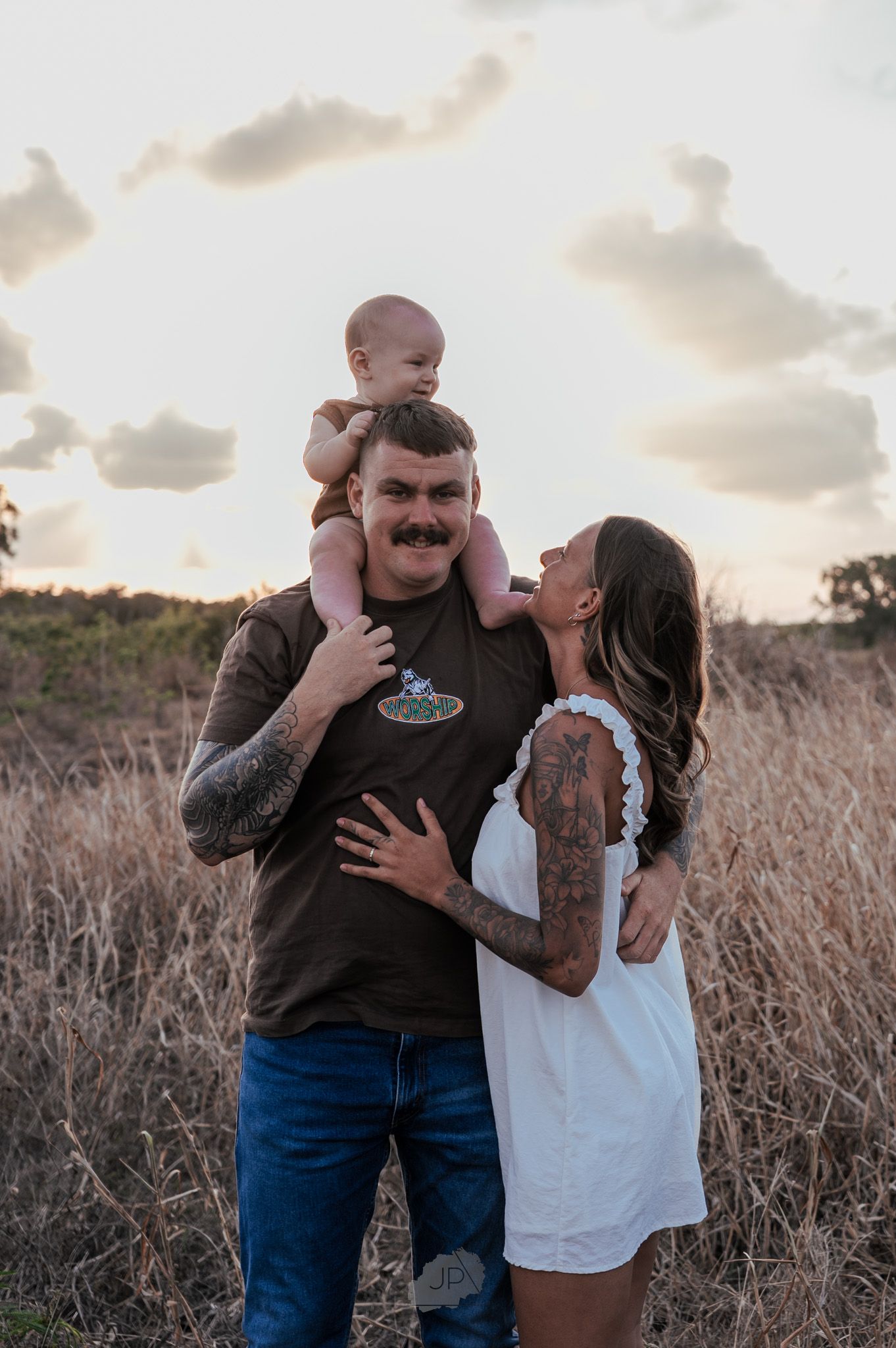 A family shares joyful moments together in a field during sunset, captured in a series of candid photographs.