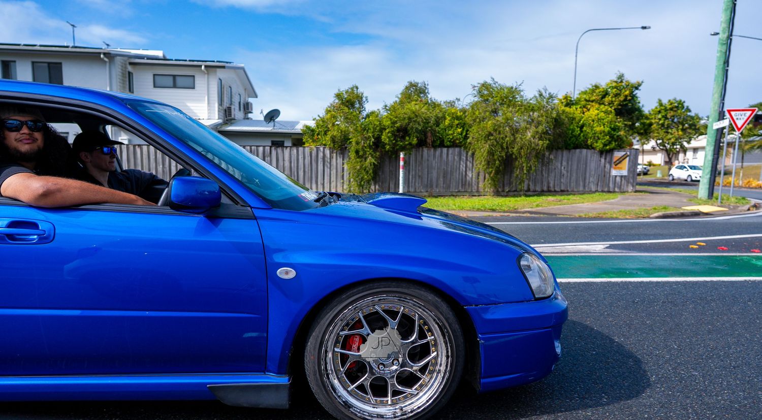A blue modified Subaru Impreza WRX displayed from multiple angles showing custom wheels and lowered suspension.