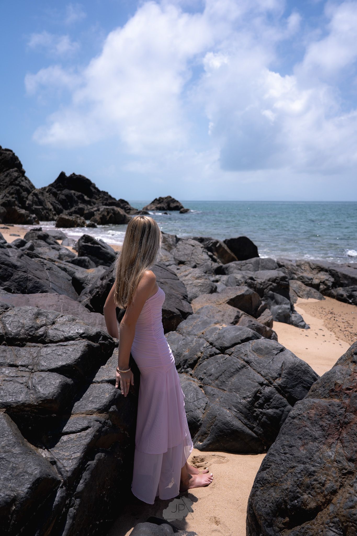 A series of photos showing a rocky beach landscape with dark volcanic rocks against blue ocean and sky.