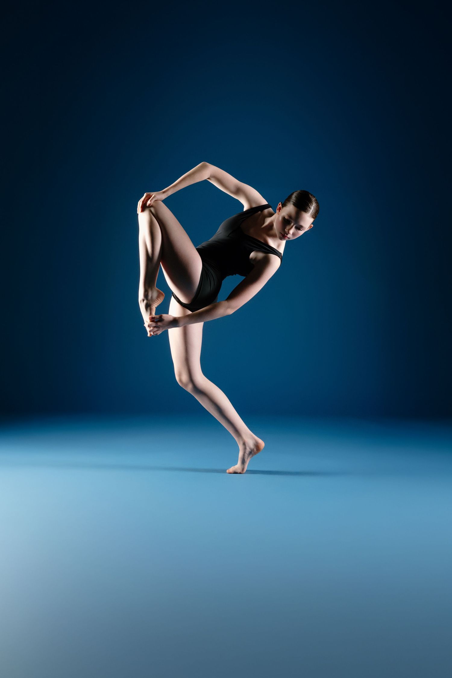Sequence of dynamic dance poses showing graceful movement against dark blue background in contemporary style.
