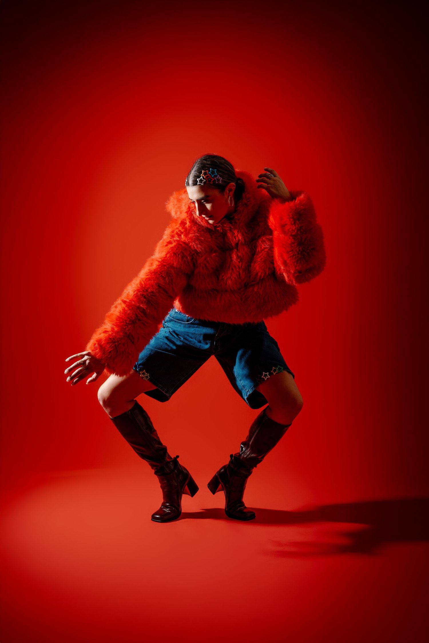 A sequence of 4 dramatic silhouette photos against a vibrant red background showing a person crouching down in motion.