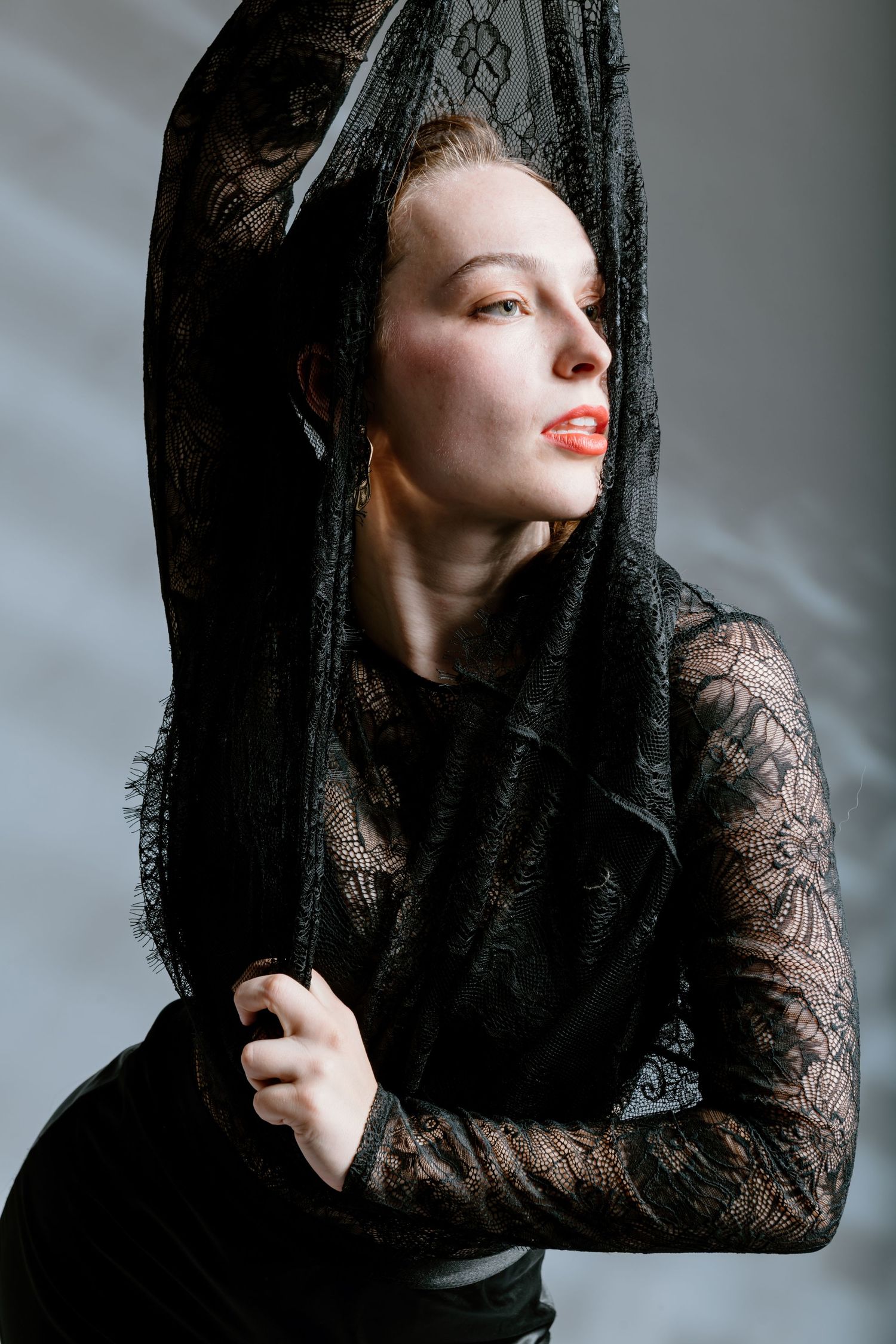 Artistic portrait series in black lace veil showing dramatic profile poses against grey background.