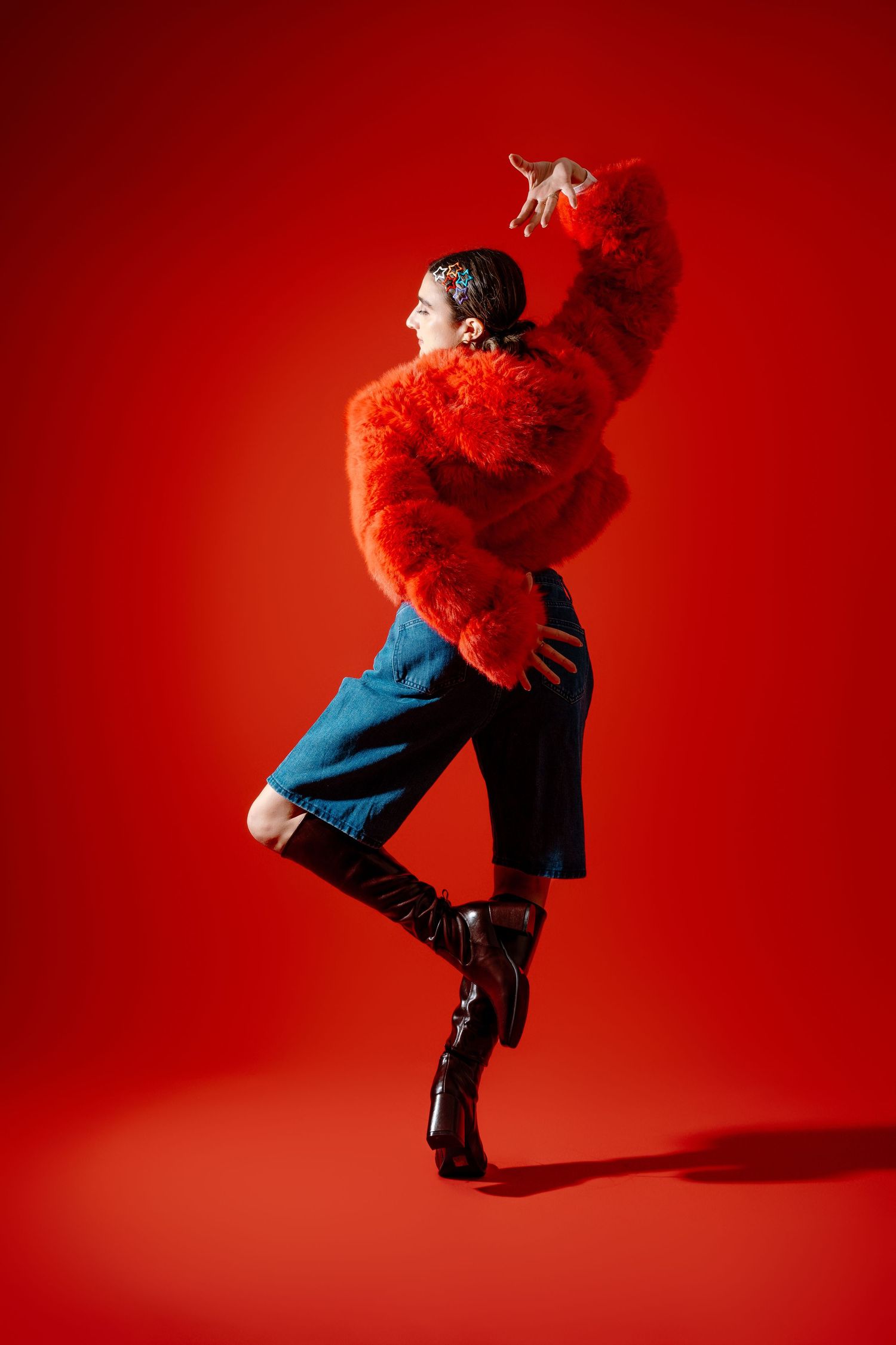 Dance sequence against vibrant red backdrop showing figure in blue dress moving dynamically through multiple poses.