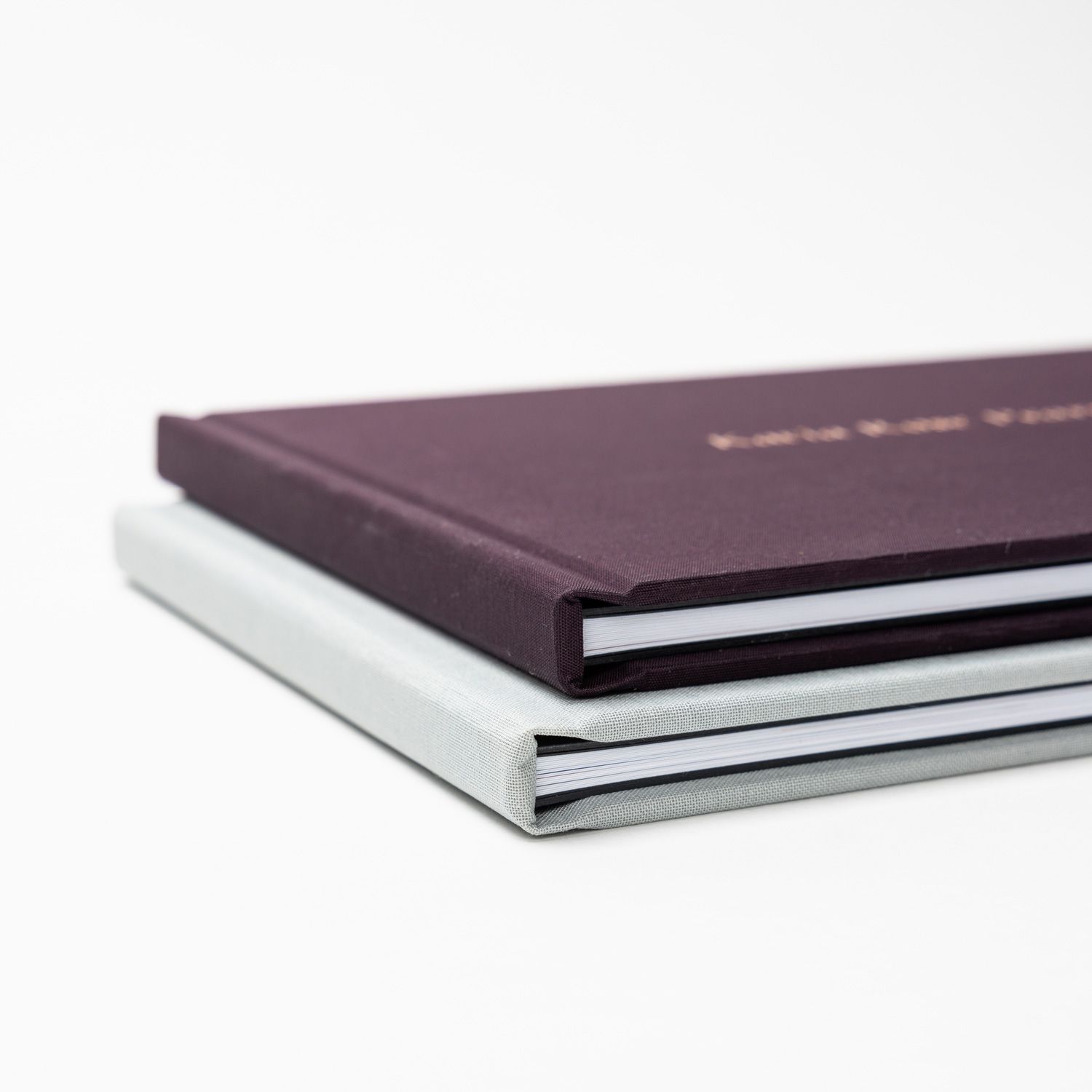 Professional photo album covers in brown and white tones arranged in a row.