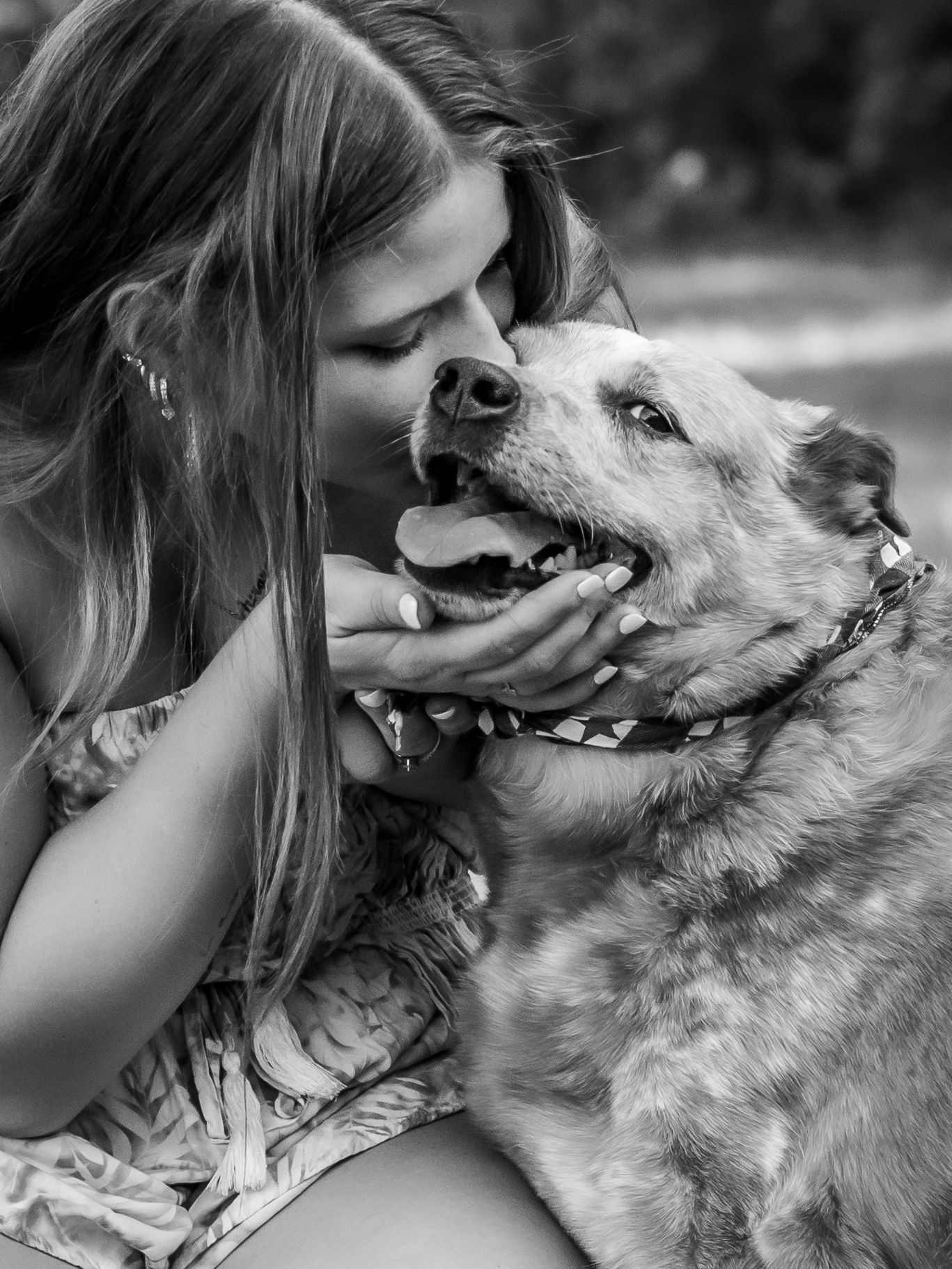 Tender moment between dog and owner in black and white portrait photography.