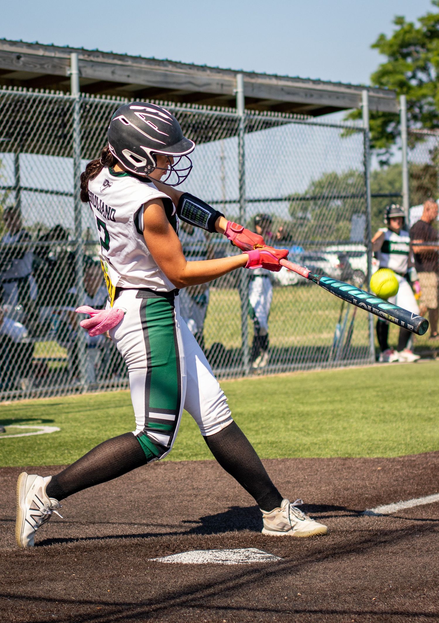 Softball players in batting stances during game sequence showing follow through swings.