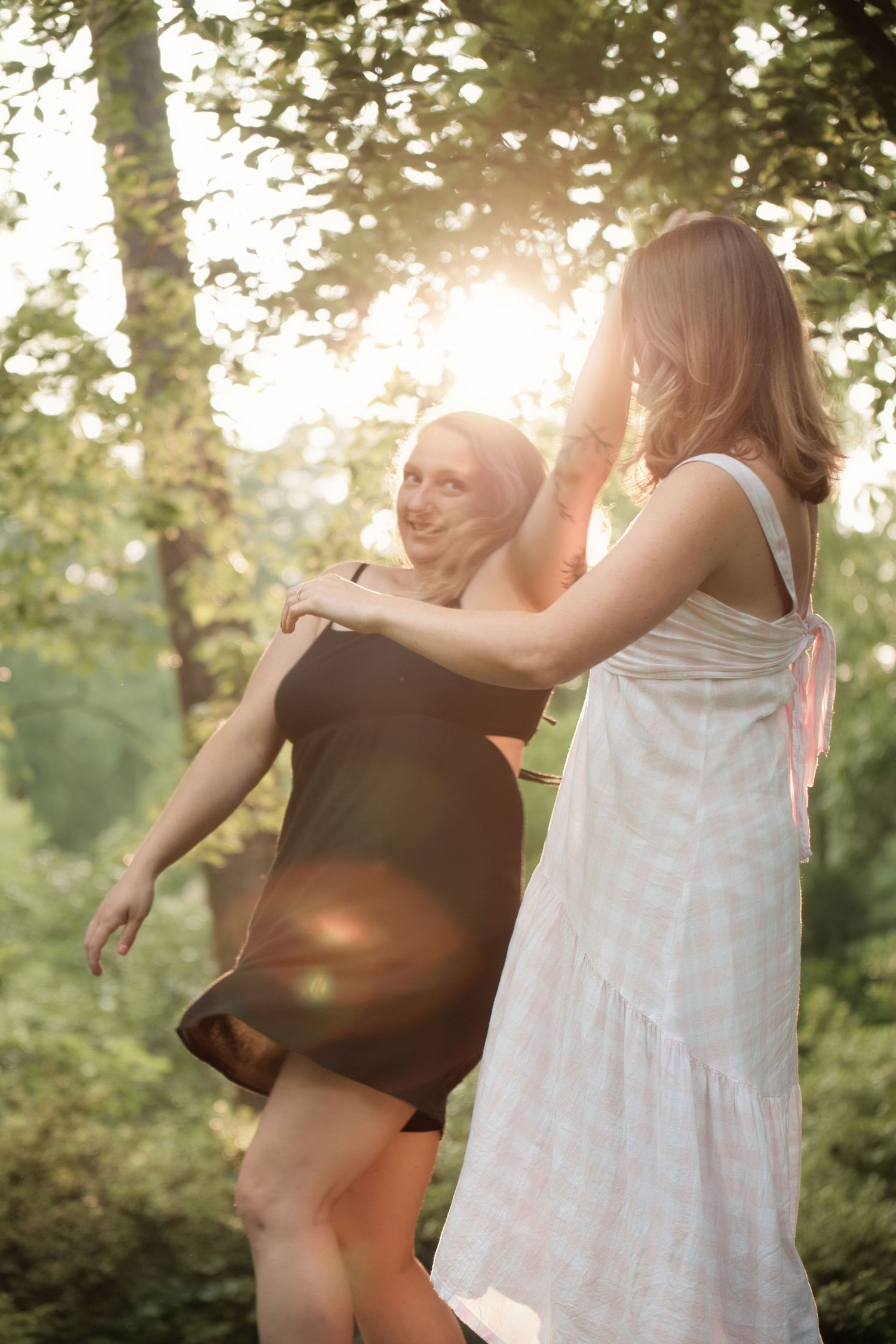 Couple dancing in sunlit forest during wedding celebration. Alex Faye Photography Alex Faye Media Wedding Raleigh