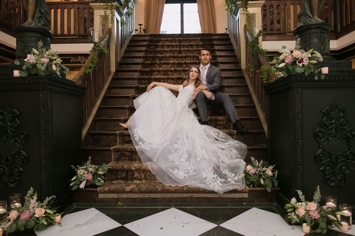 Wedding photography featuring a bride posing gracefully on vintage wooden stairs with floral decorations. Alex Faye Media Raleigh