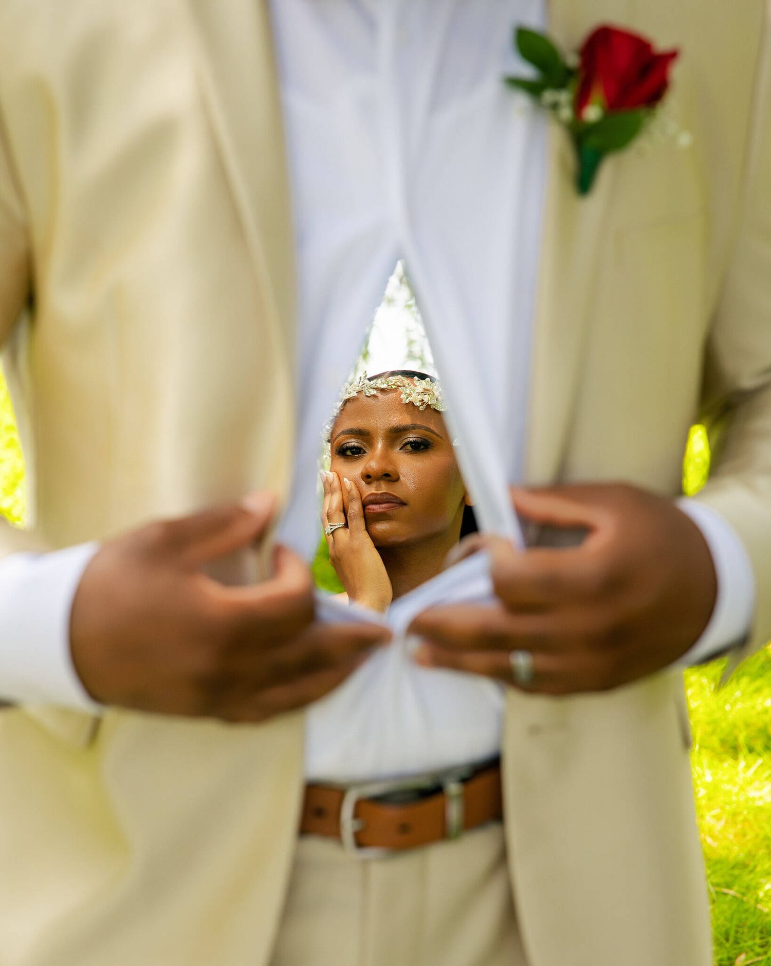 Artistic wedding portrait of a bride reflected in the groom’s chest using a mirror