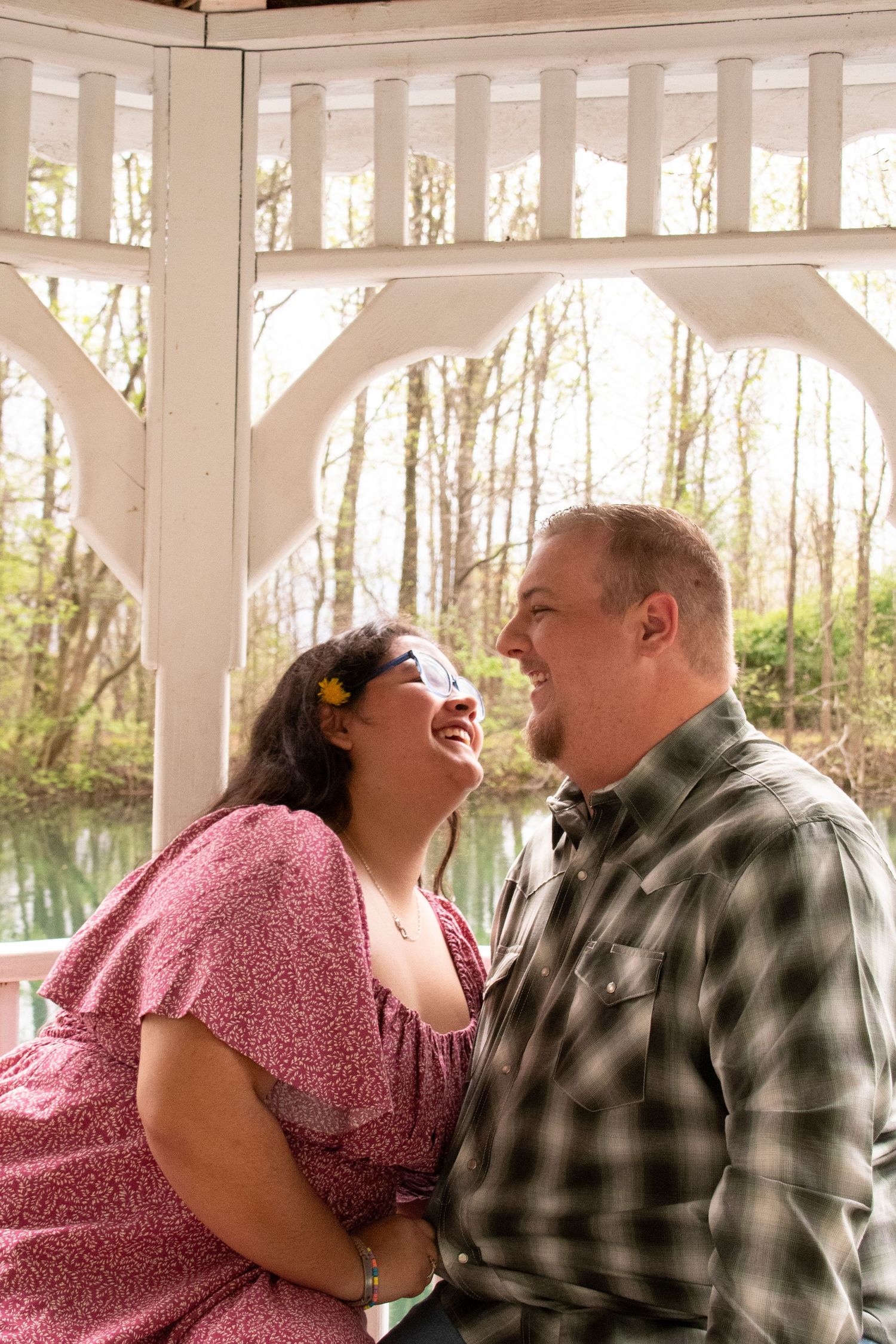 Couple smiling naturally during an outdoor portrait session