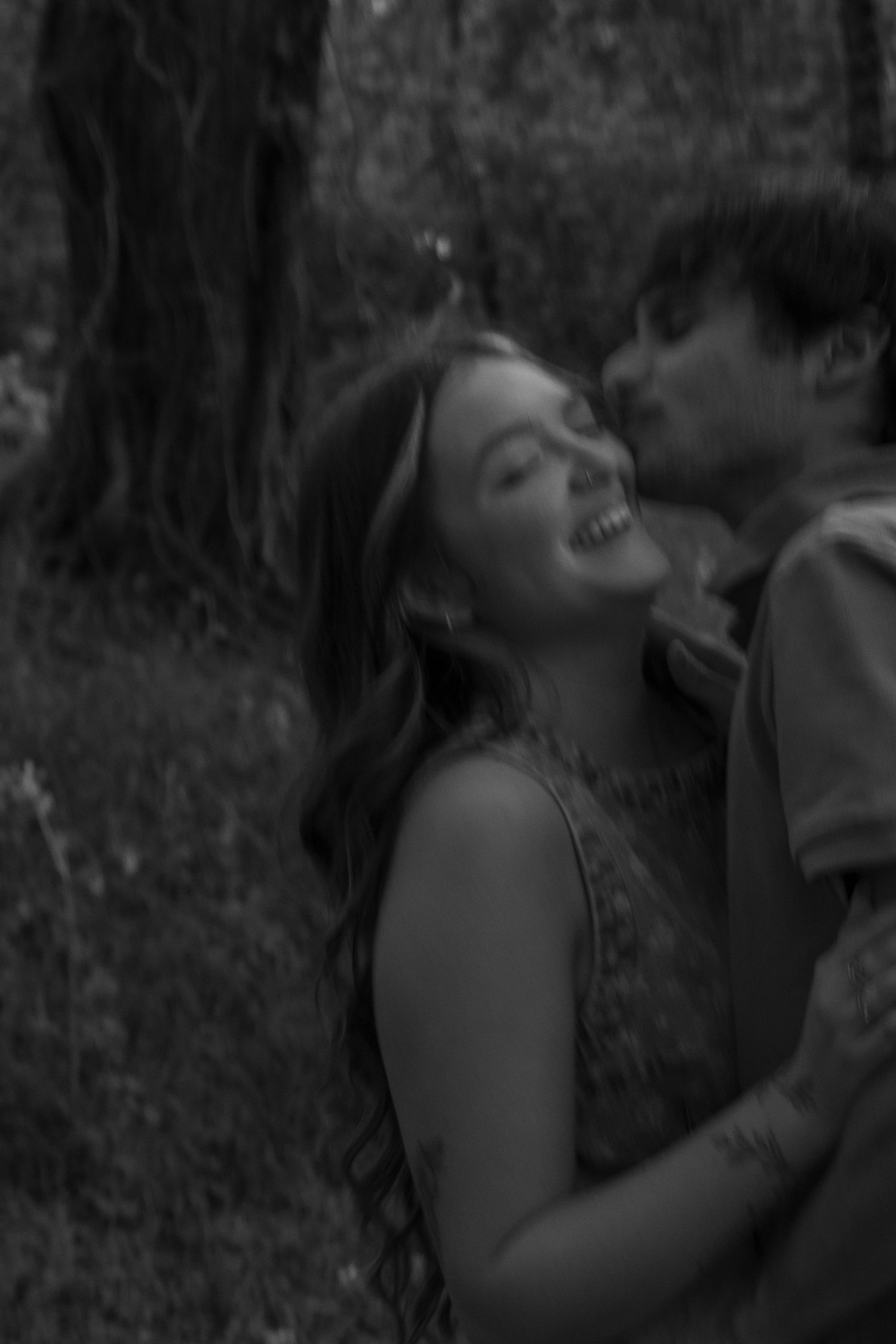 Couple smiling naturally during an outdoor portrait session