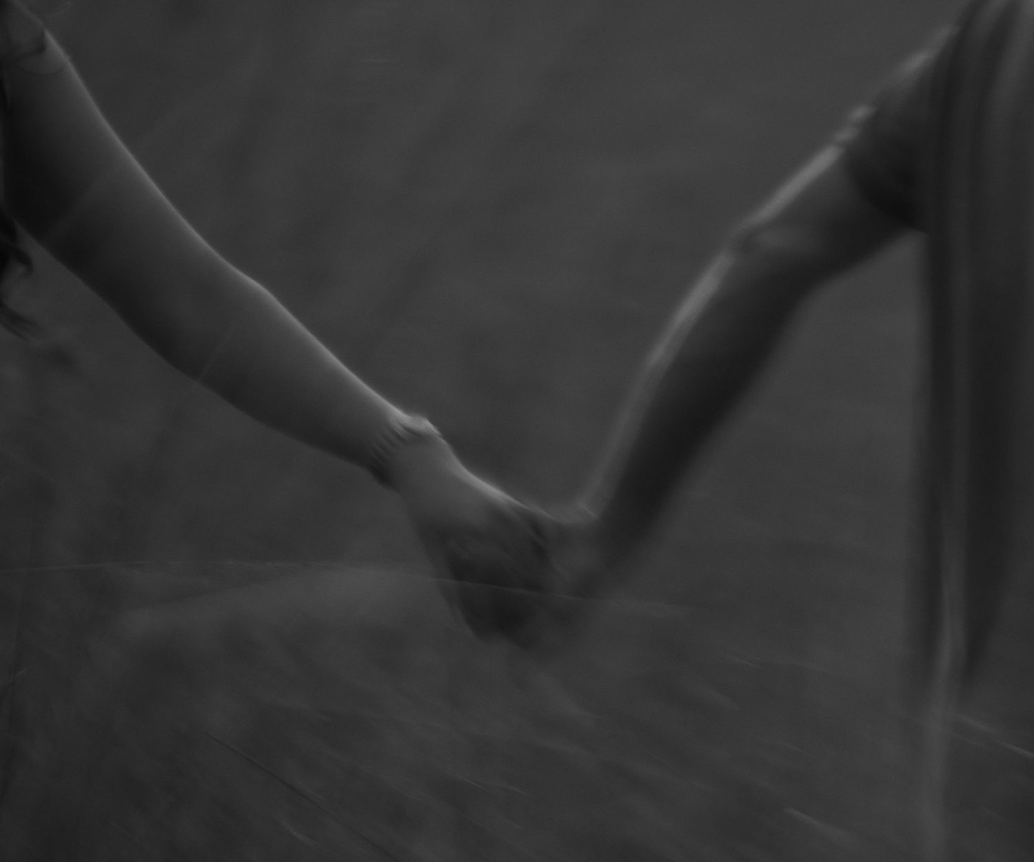 Documentary-style portrait of a couple walking hand in hand
