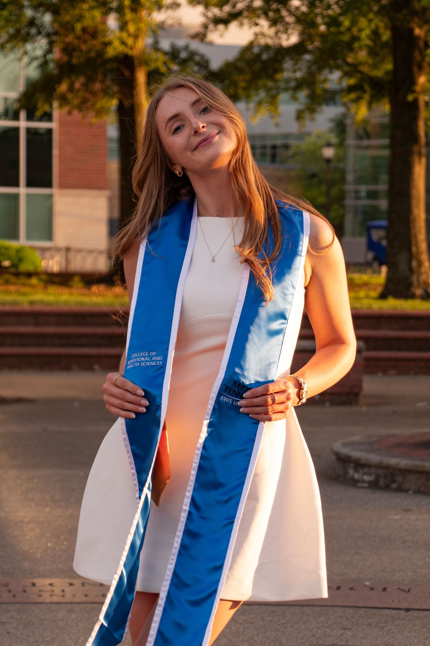 Graduate holding their graduation cap and diploma