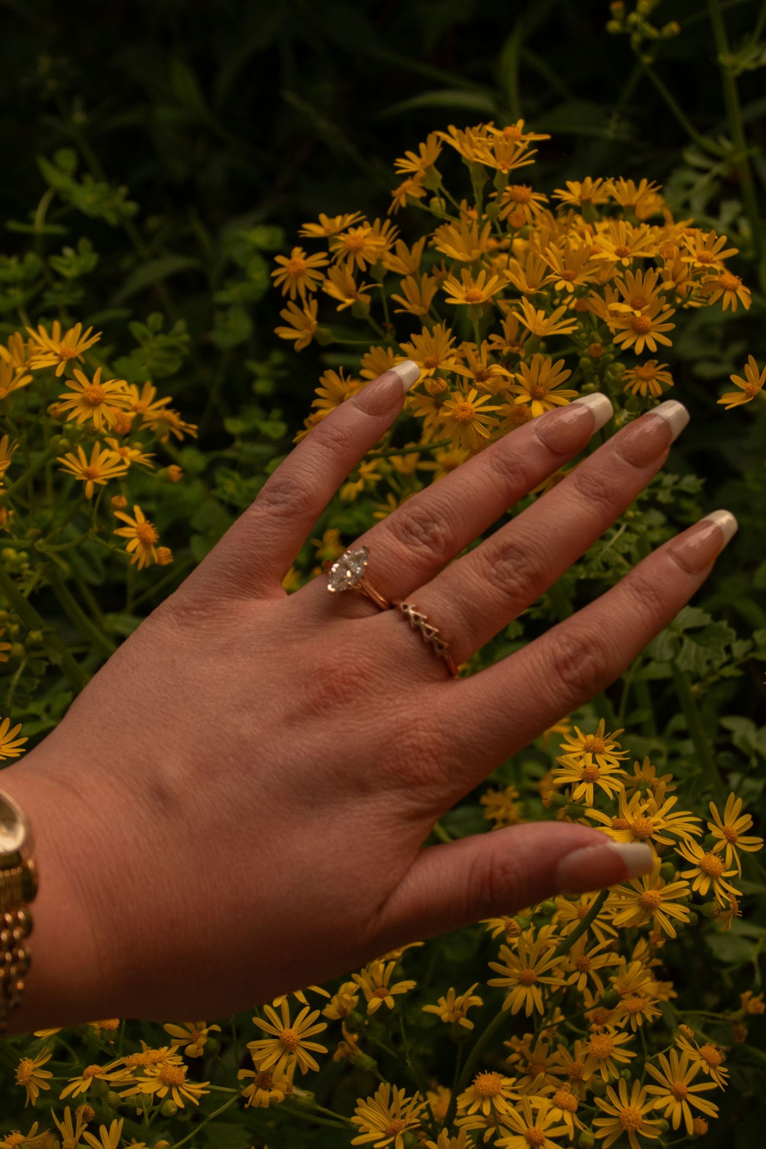 Engagement Ring on the Bride in front of flowers