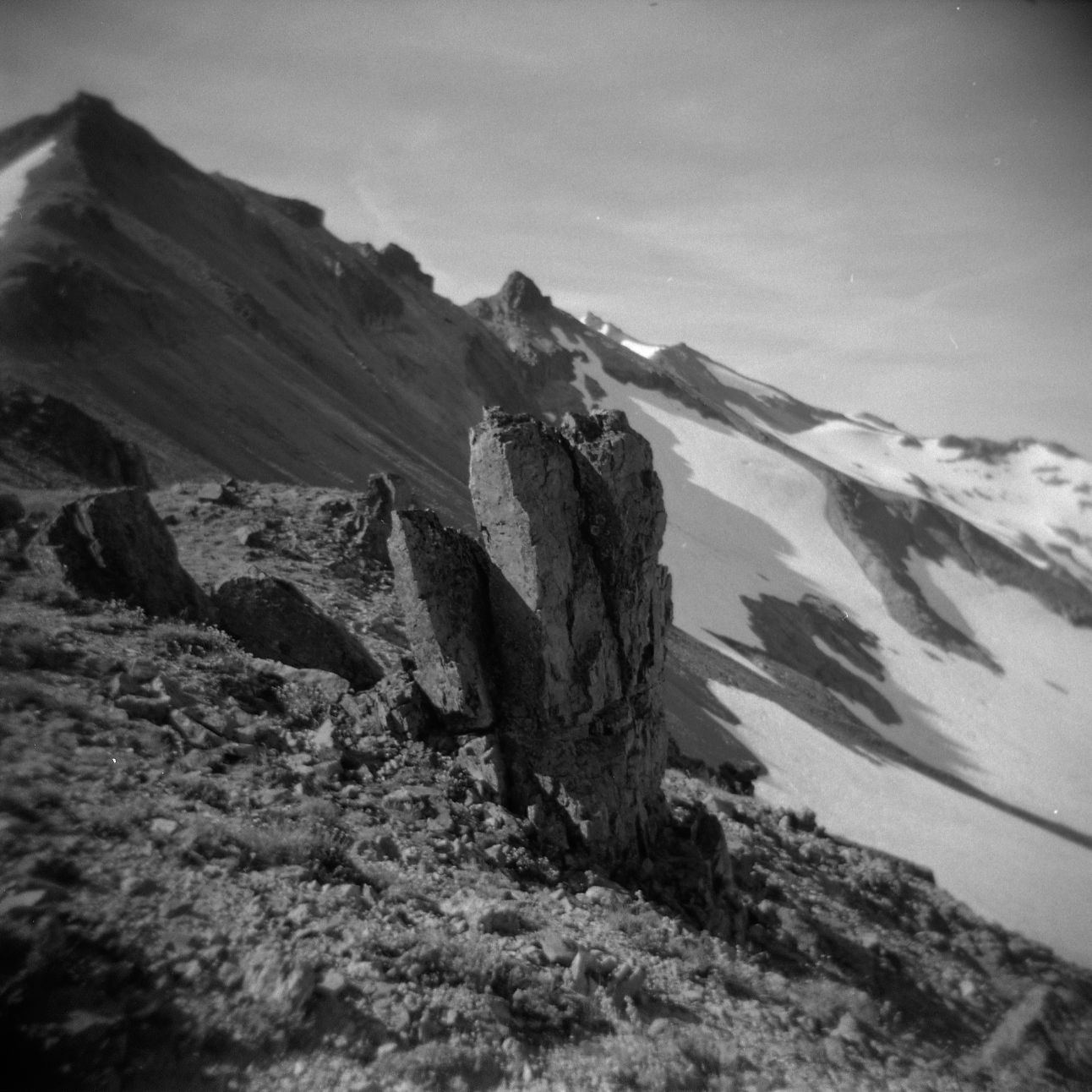 A black and white film Holga photograph of a rock outcrop in the Goat Rocks Wilderness on the Pacific Crest Trail in Washington.