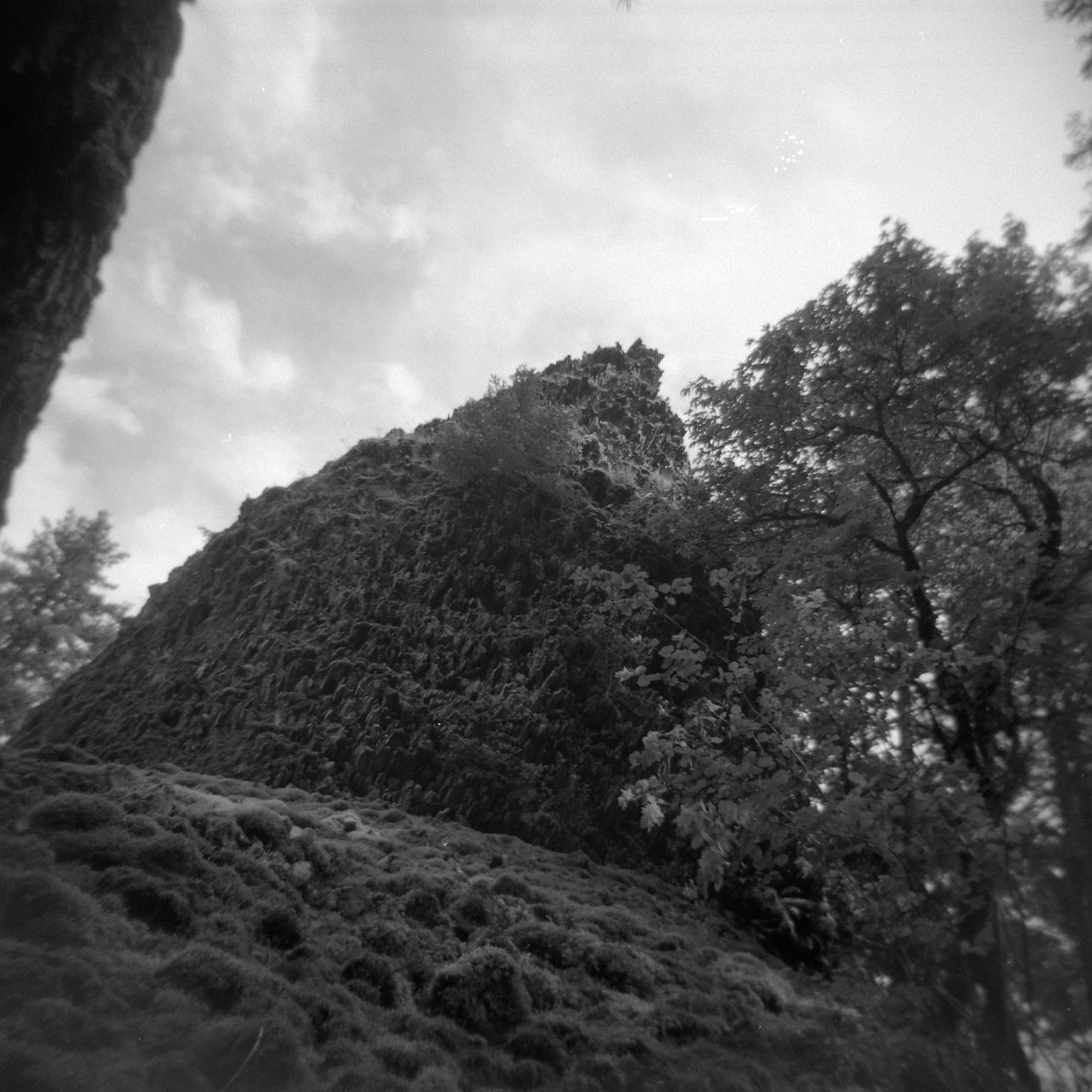 A black and white film Holga photograph of a mysterious rock formation in a canyon along the Pacific Crest Trail.