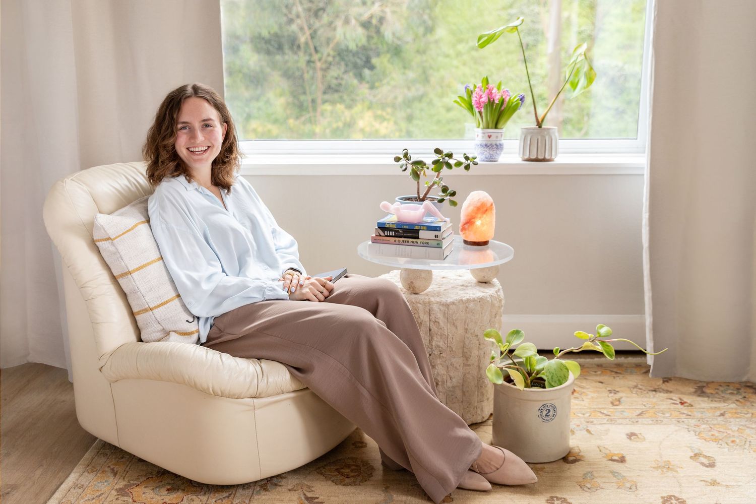 Relaxing lifestyle photos of someone lounging on a white couch in a bright, plant-filled room.
