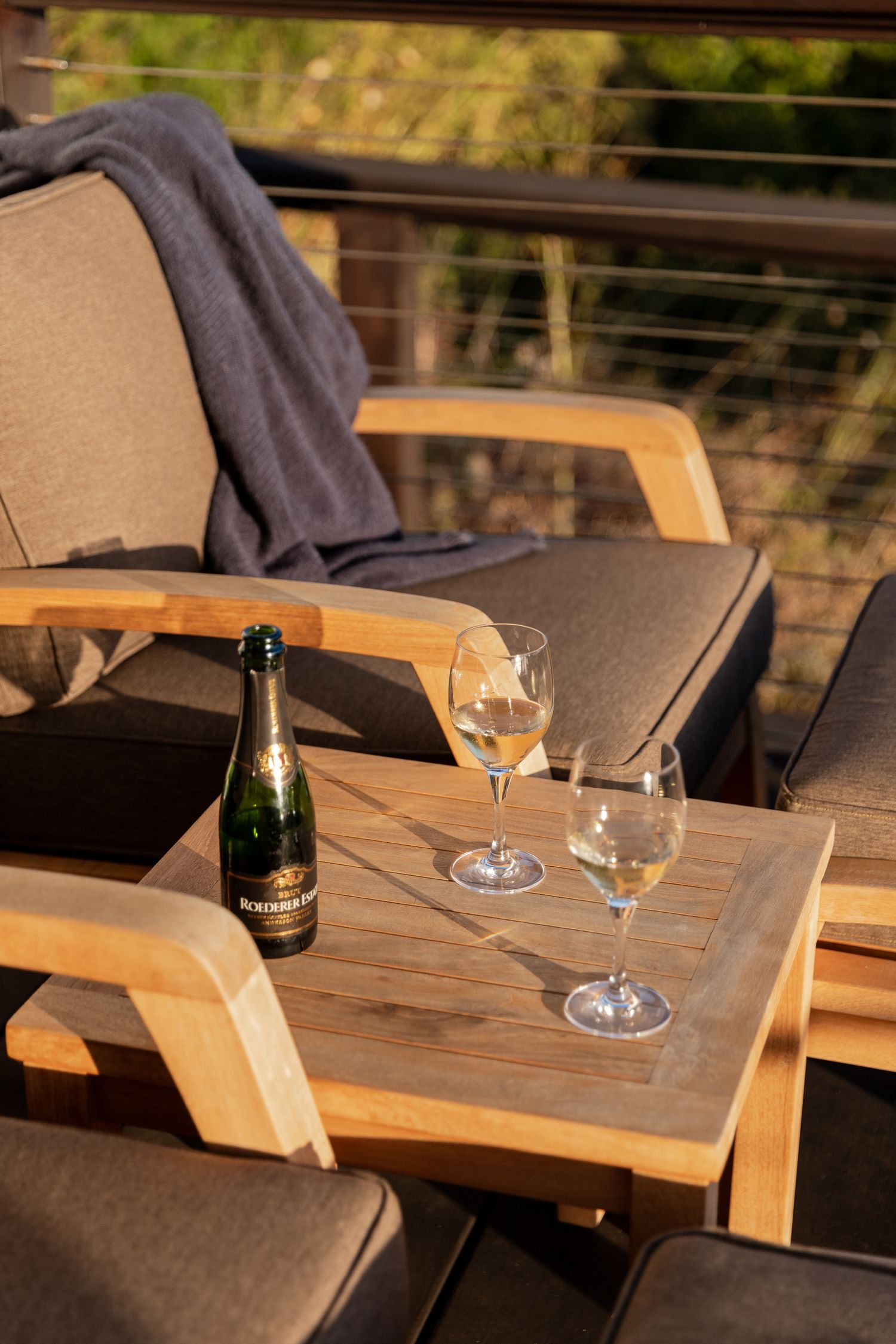 A wooden outdoor table with wine. Professional photographer Colorado. Brand photography. Travel photographer. Hospitality, Hotel photography