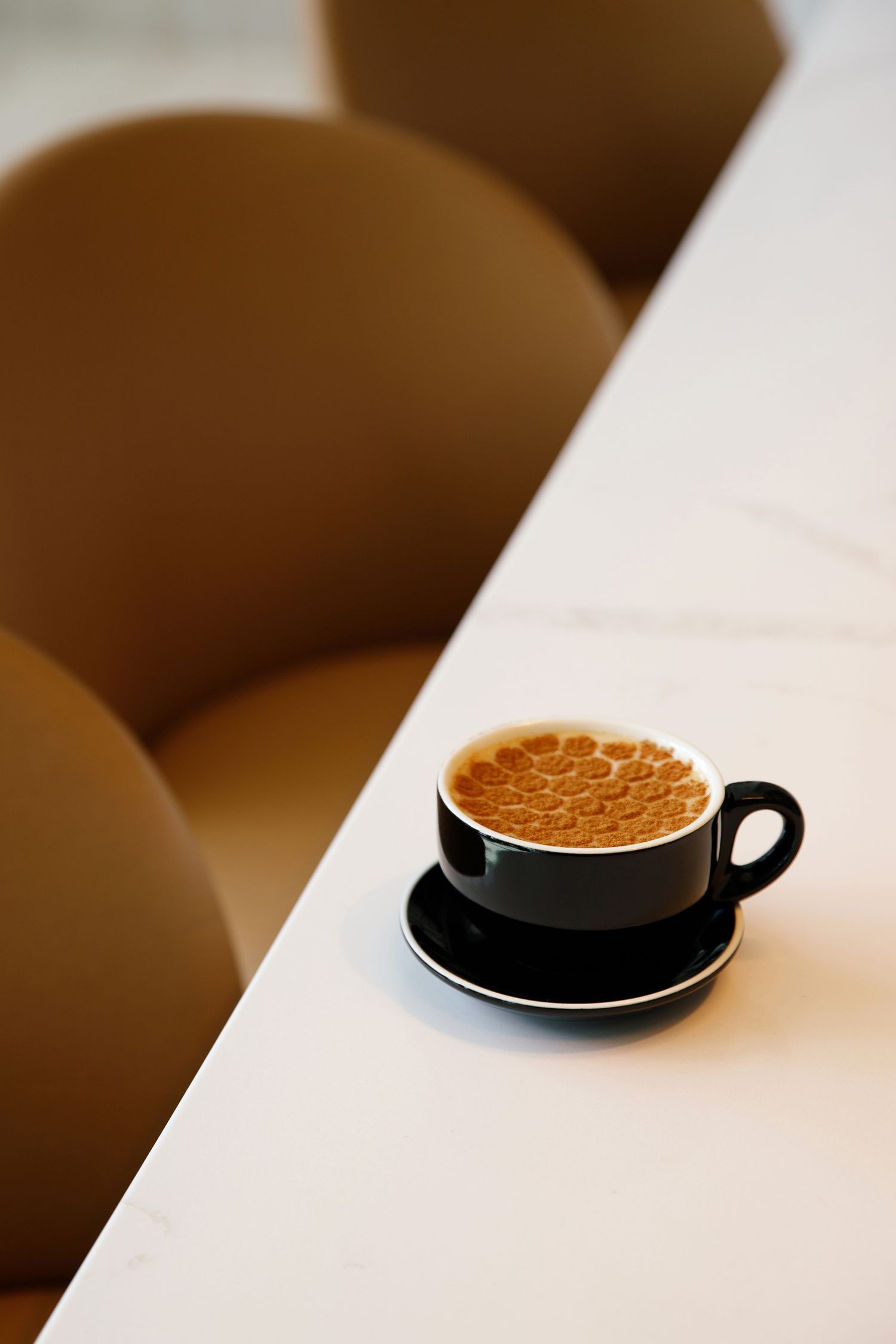 Artisan cappuccino on marble backdrop. Commercial Photographer in Colorado.