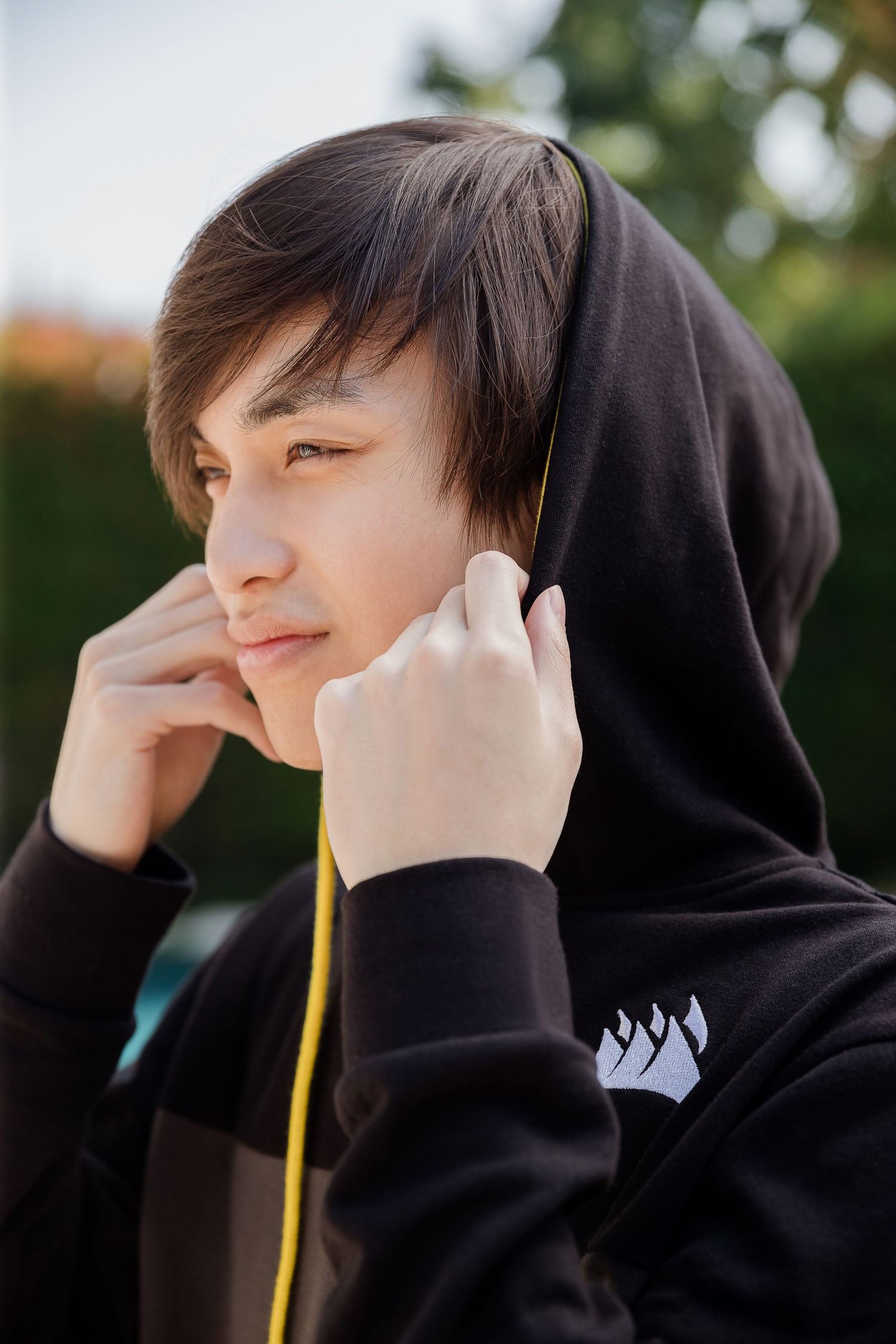 Portrait photography for men by Denver based commercial photographer Adrian Kahn. Photograph is a close up profile of a man in a hoodie.