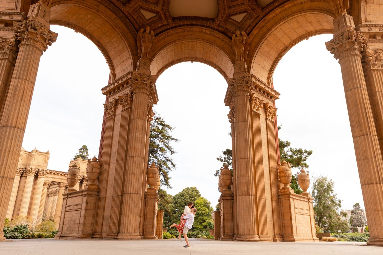 Ornate stone archways and columns of the Palace of Fine Arts create a dramatic architectural perspective in San Francisco.