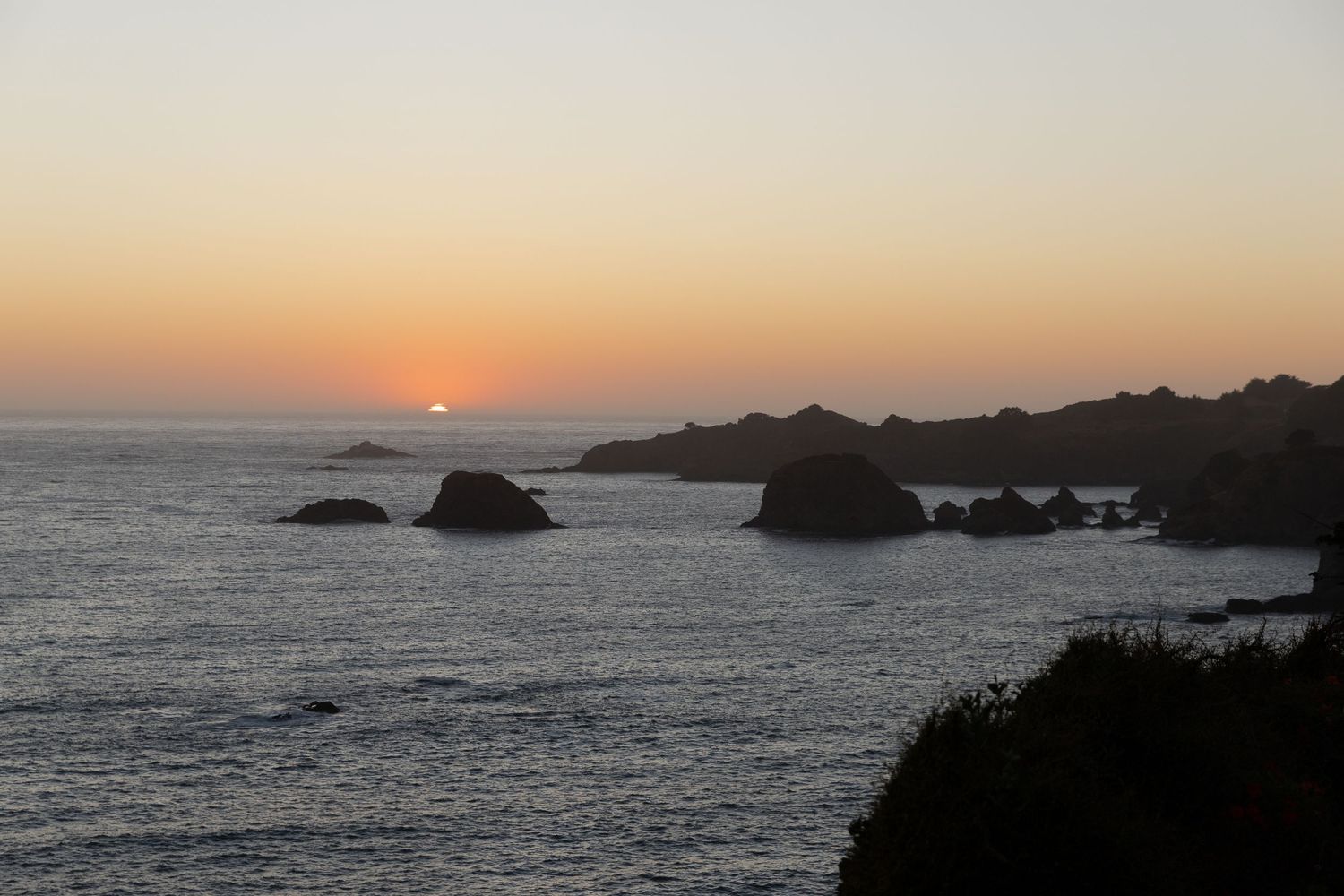 Dramatic sunset over rocky coastal cliffs. Colorado travel photographer. Editorial photographer for Travel and Leisure.
