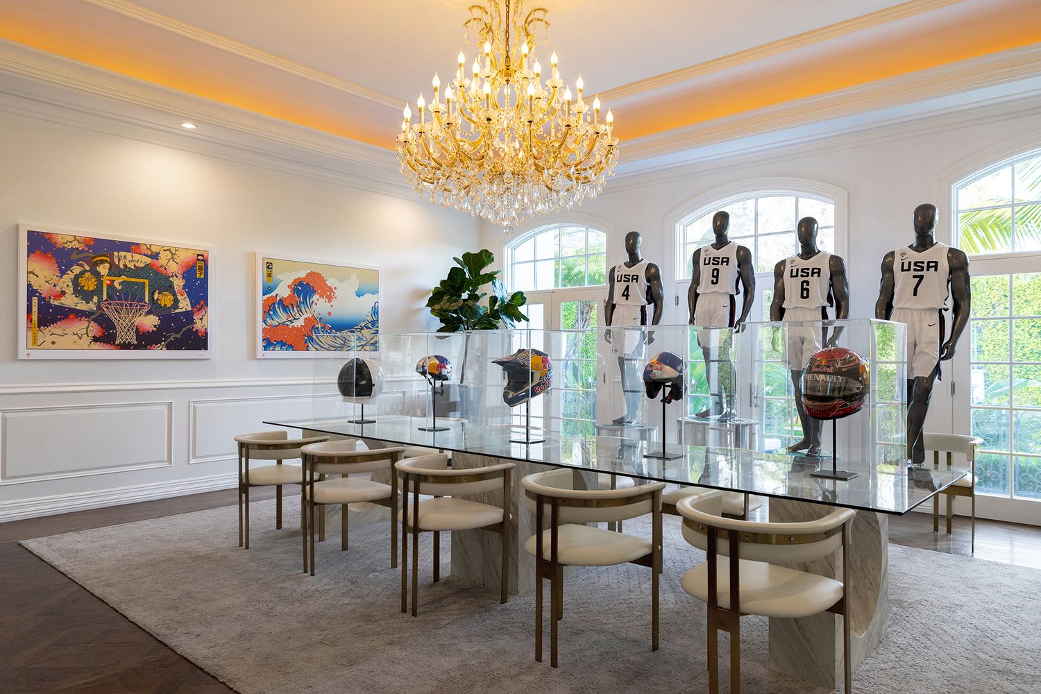 Elegant white showroom with mannequins displayed in a row under crystal chandeliers and natural lighting.