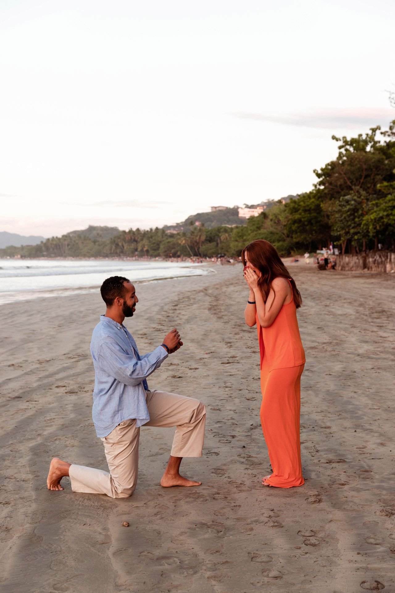 A sequence of photos capturing a surprise marriage proposal on a scenic beach at sunset.