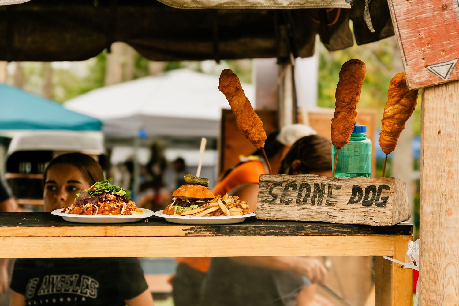 Food vendor stall at an outdoor festival serving traditional dishes.