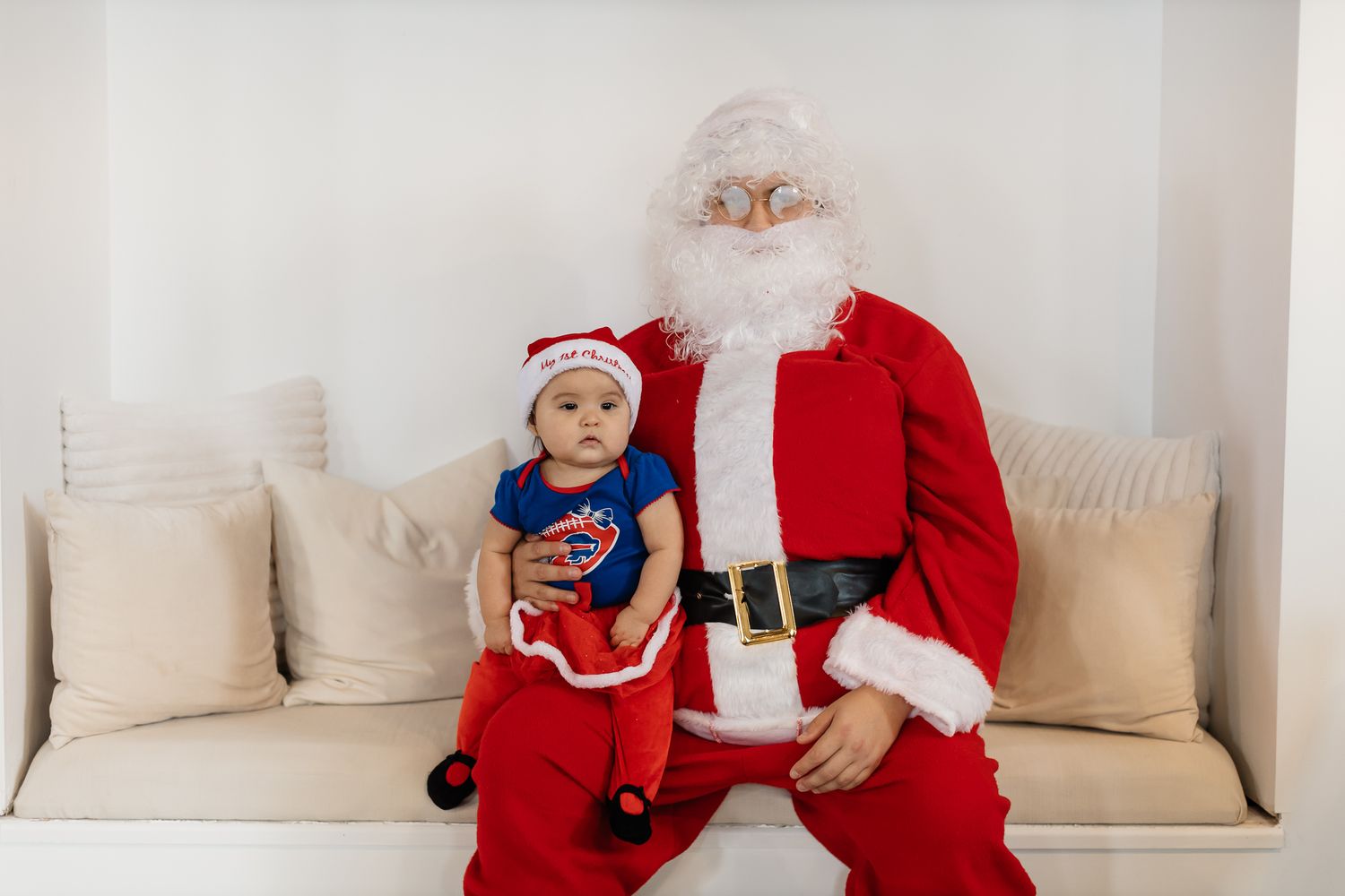 Christmas themed photo session with Santa Claus decorations and red accents.