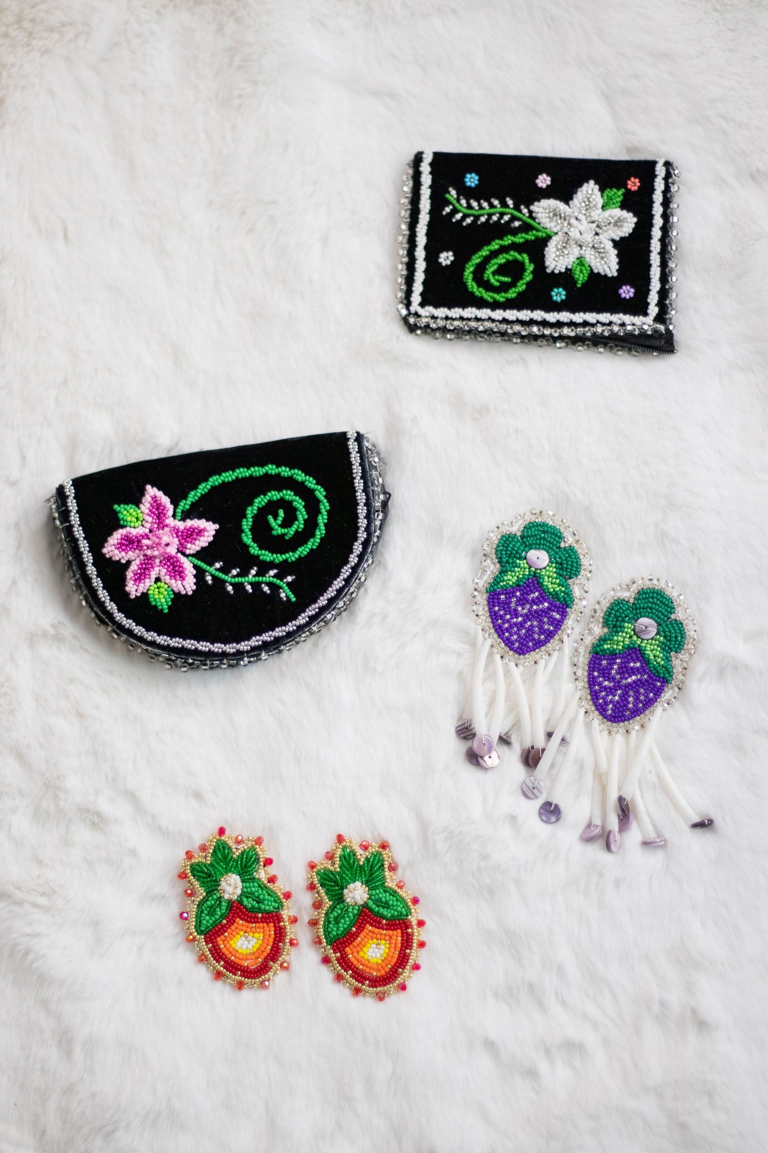 Collection of colorful beaded earrings with floral and geometric patterns.