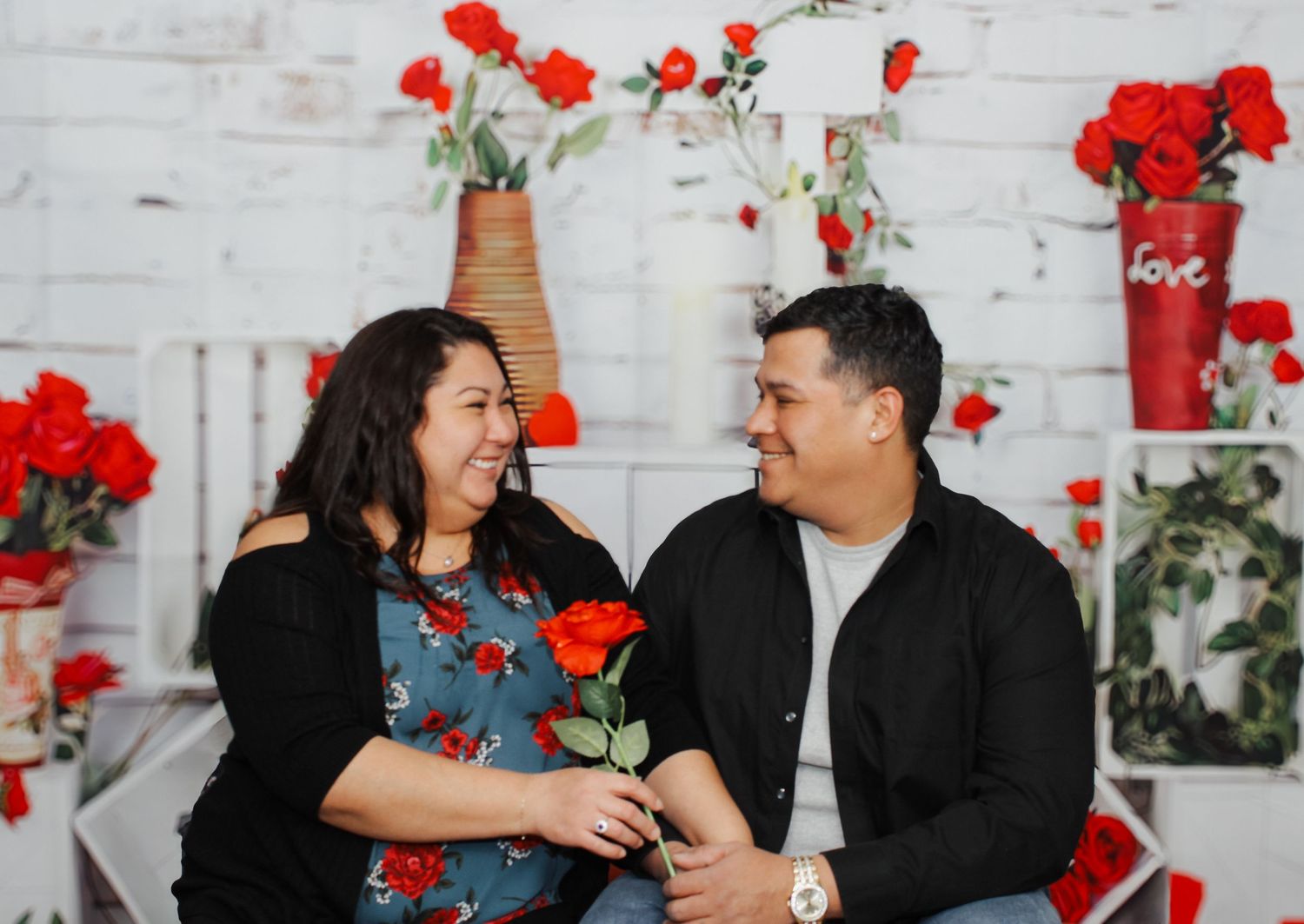 Casual family portrait session with romantic Valentine's day backdrop and decorations.