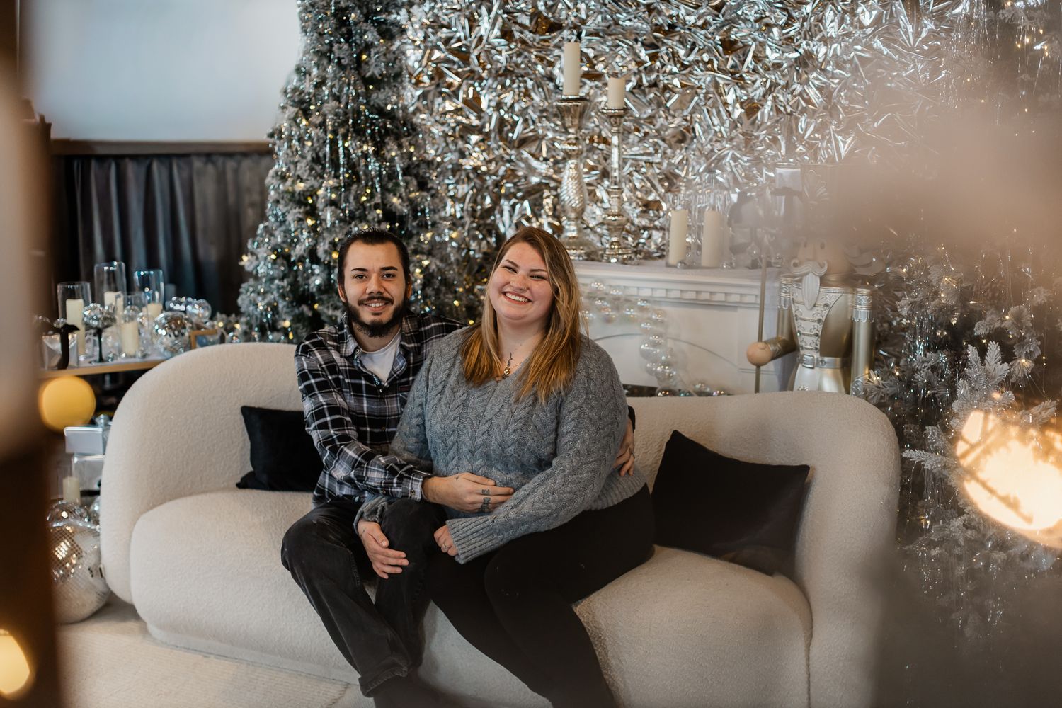 Cozy indoor family photoshoot with warm lighting and holiday decorations.