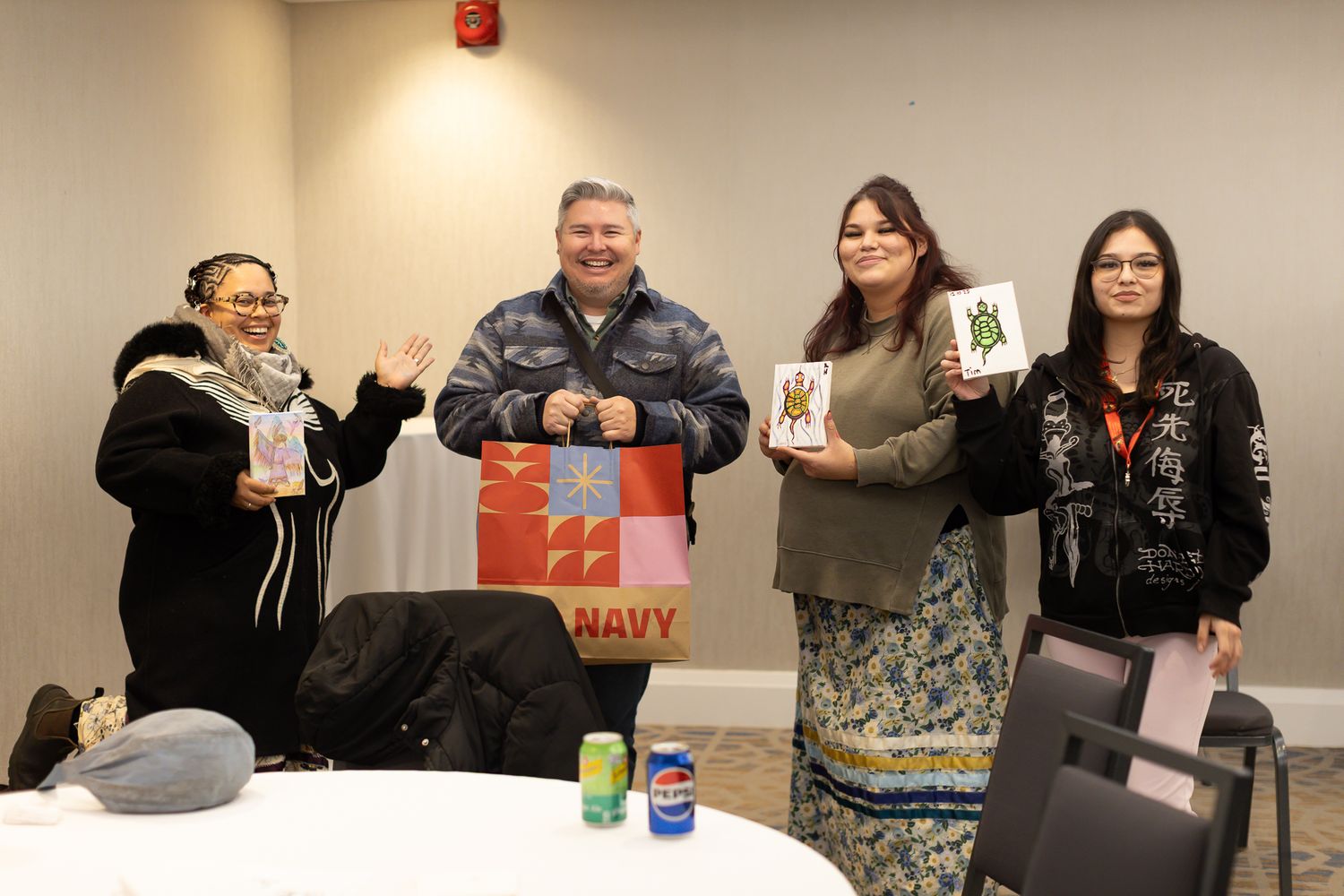 Attendees participating in activities at tables during an indoor event.