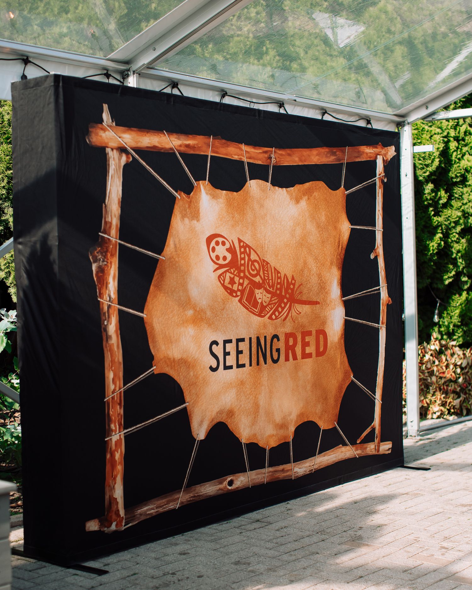 Rustic brown banners with 'SeeingRed' branding displayed at an outdoor venue.
