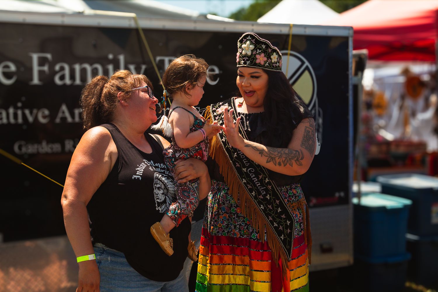 Festival participants in colorful attire enjoying outdoor celebrations.