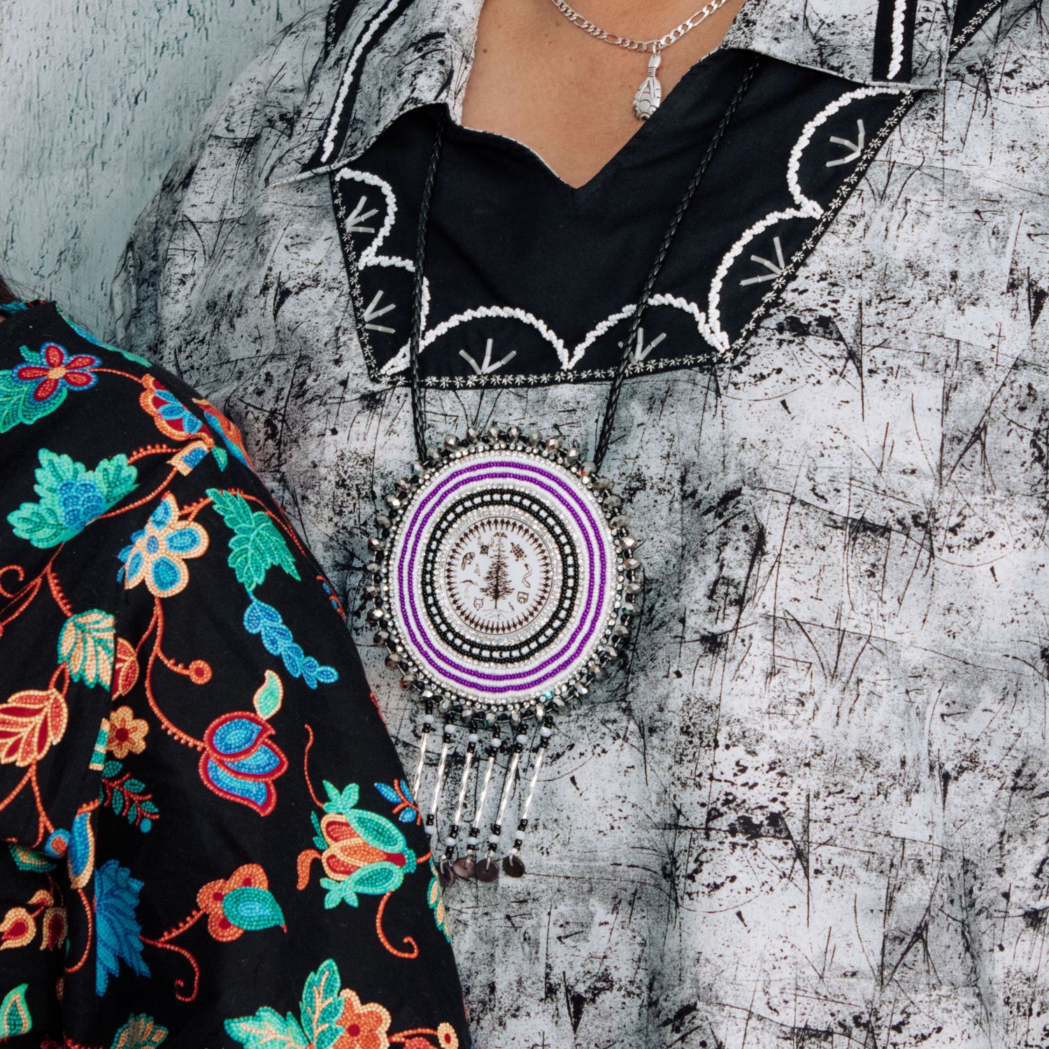 Intricate beaded accessories with floral motifs displayed against distressed gray wall texture.