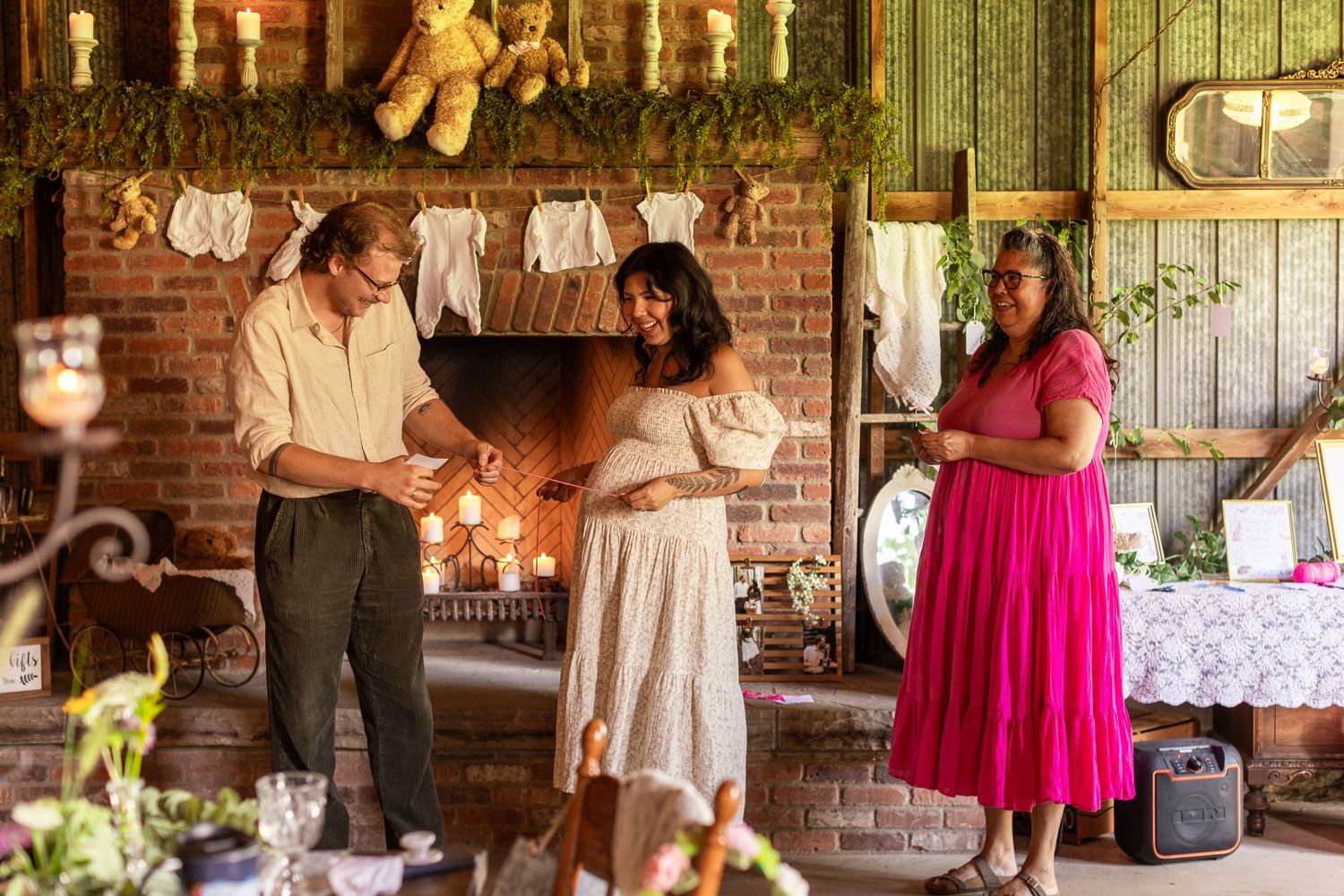 Wedding guests mingle and celebrate at a rustic indoor reception venue with exposed brick walls and warm lighting.