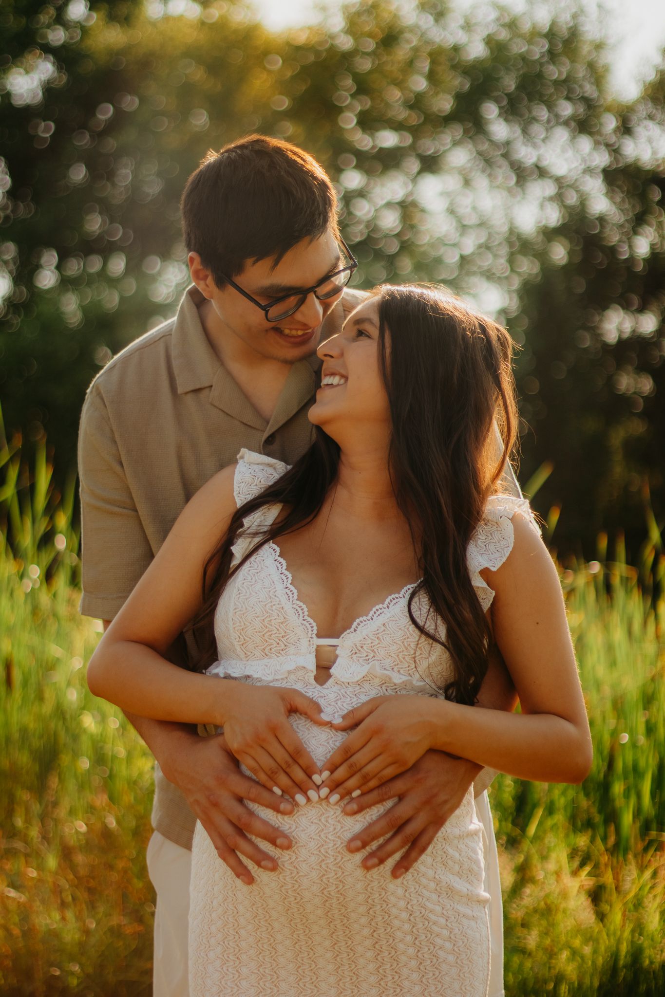 A loving couple sharing intimate moments during a golden hour photoshoot.