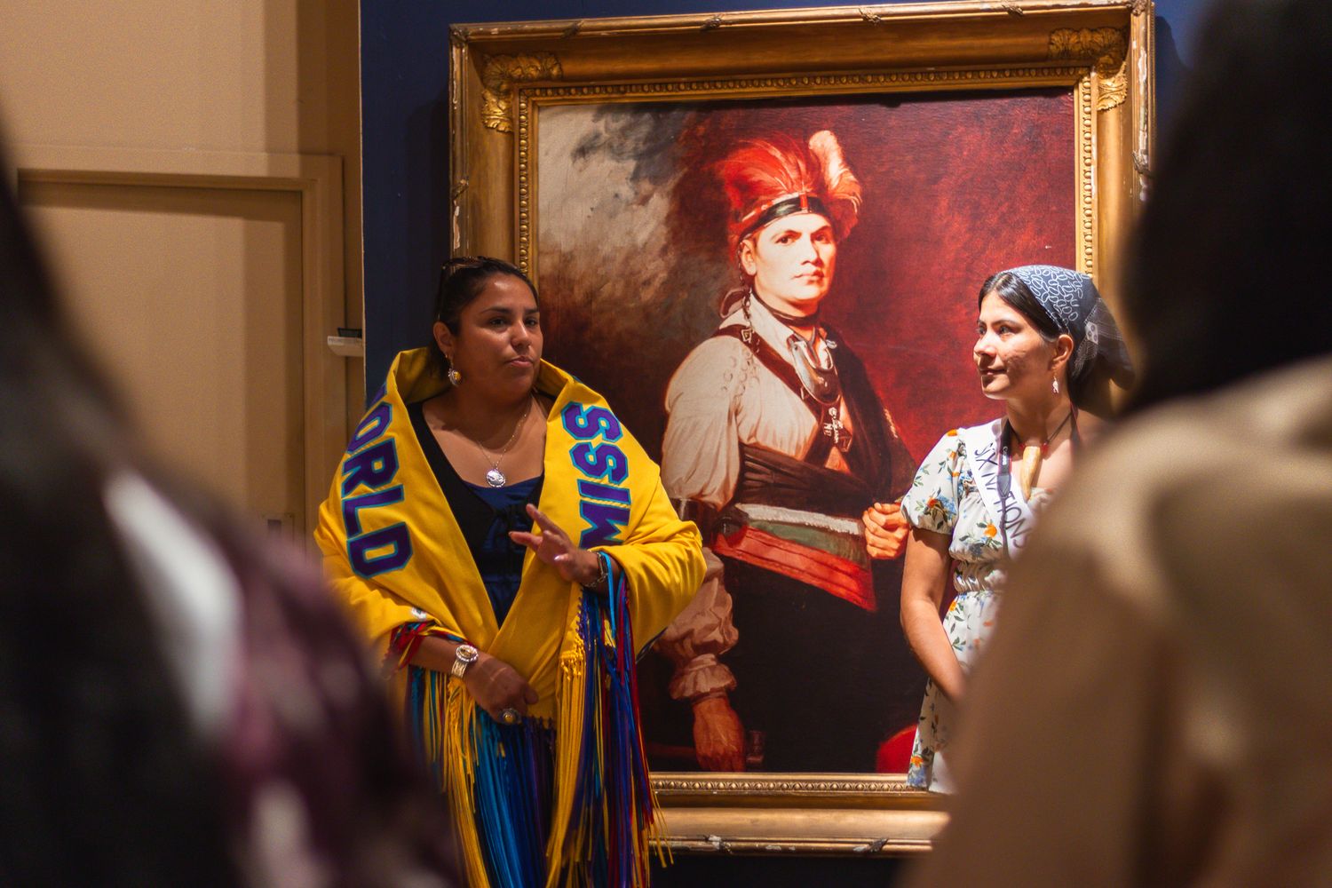 Museum gallery wall displaying historical portraits and artwork.