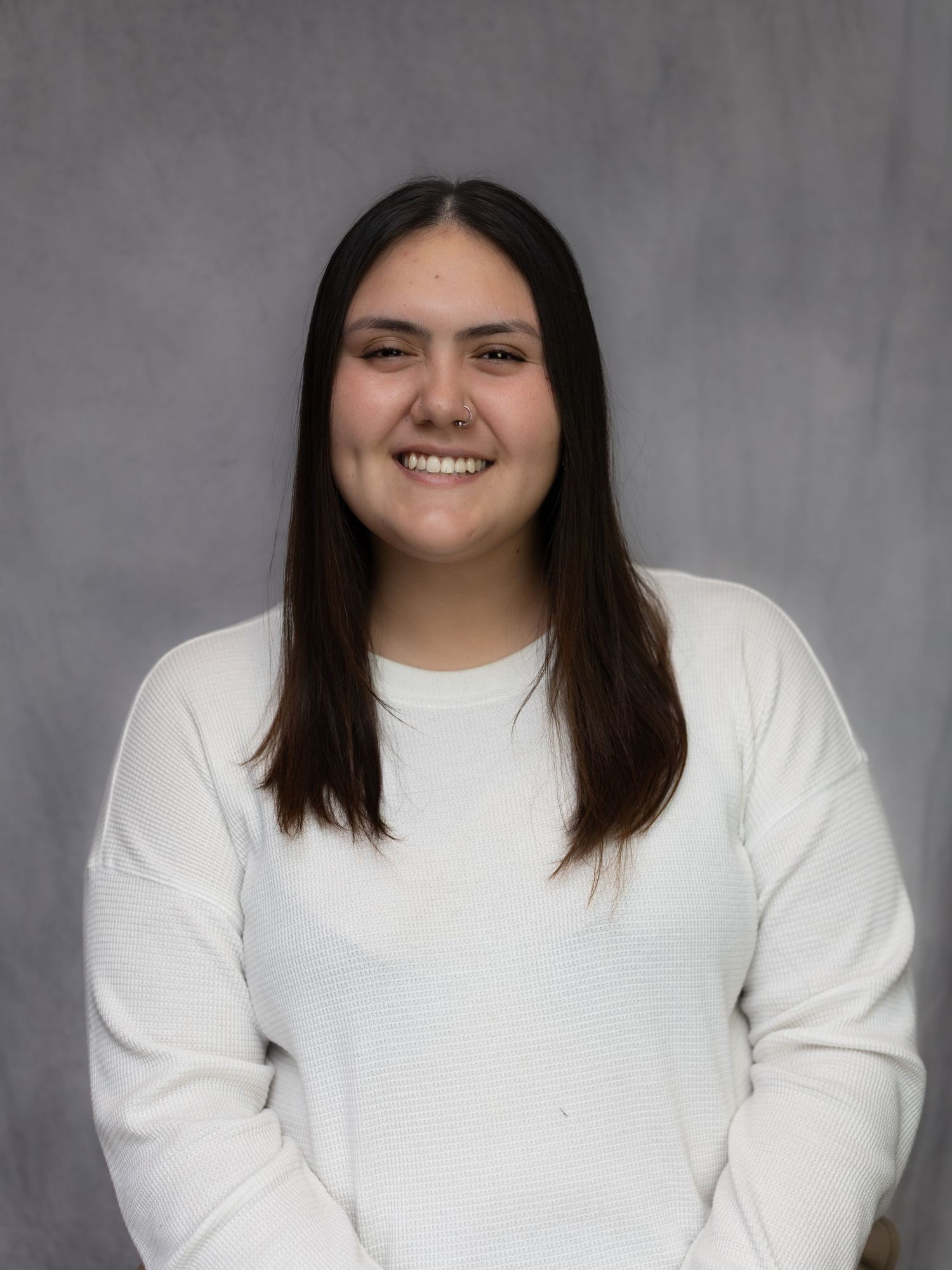 Studio portraits showing a person in a white sweater against a neutral gray background.