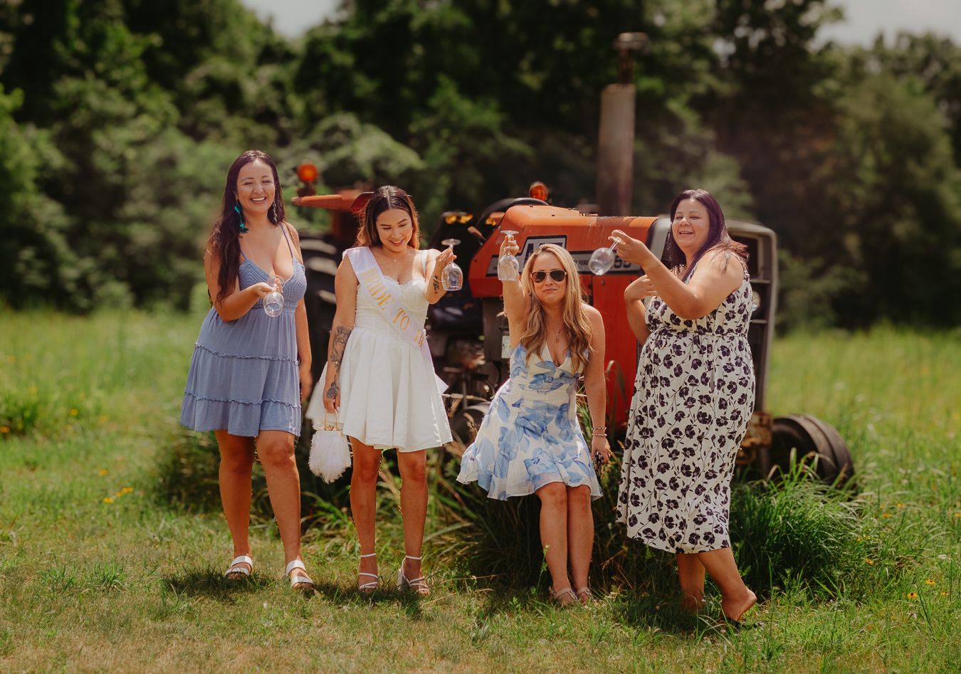 Group of friends gathered outdoors for celebration in natural setting.
