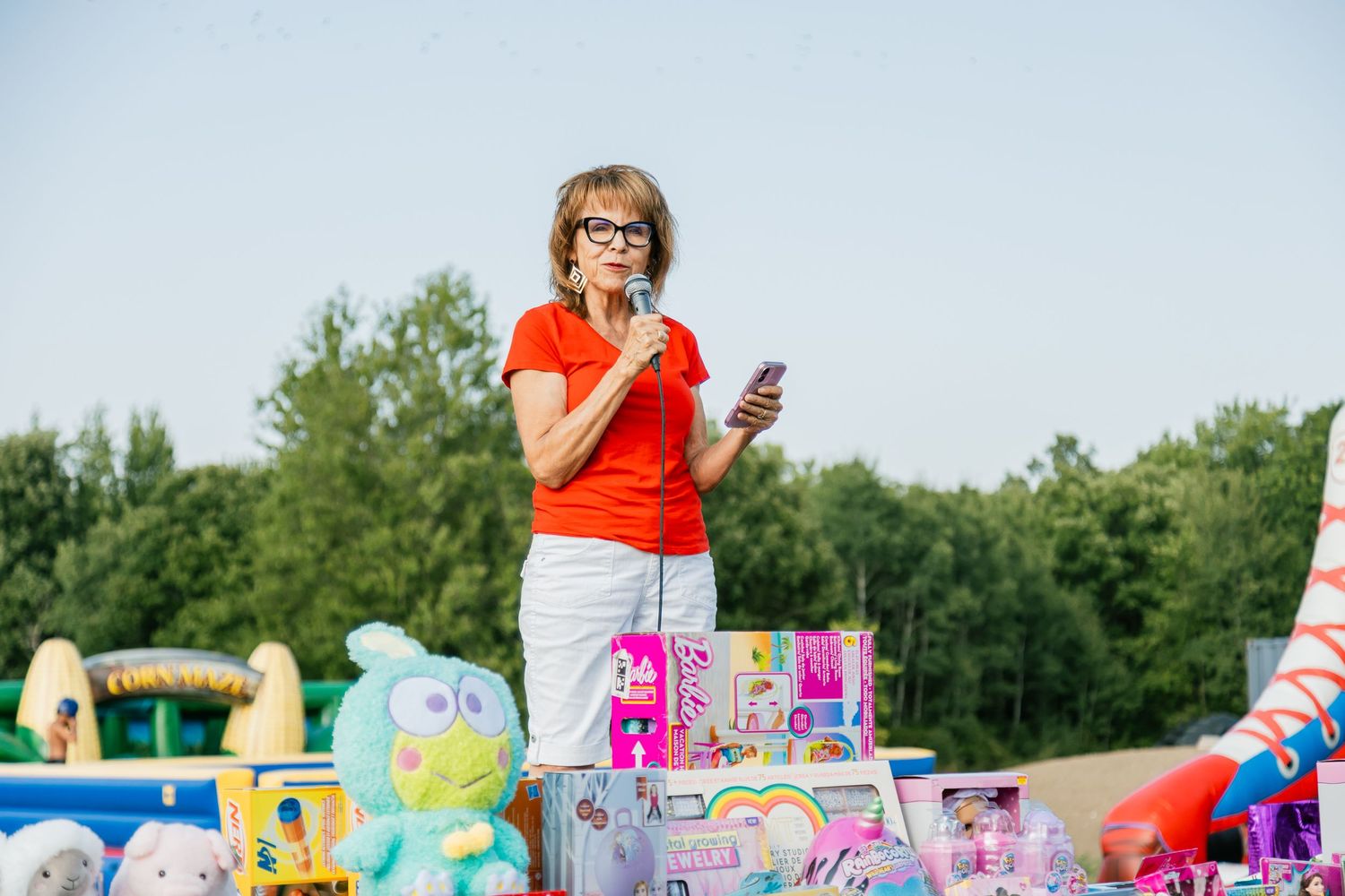 A display of colorful toys and prizes set up at an outdoor carnival or fair.