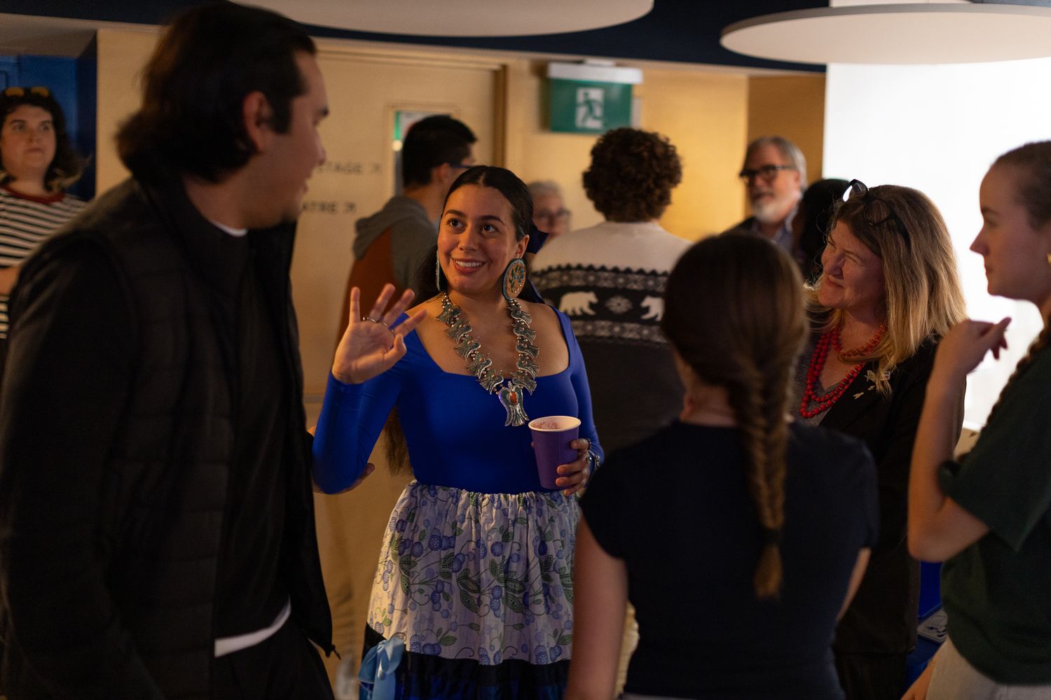 Guests gathered at a social event in a brightly lit indoor venue.