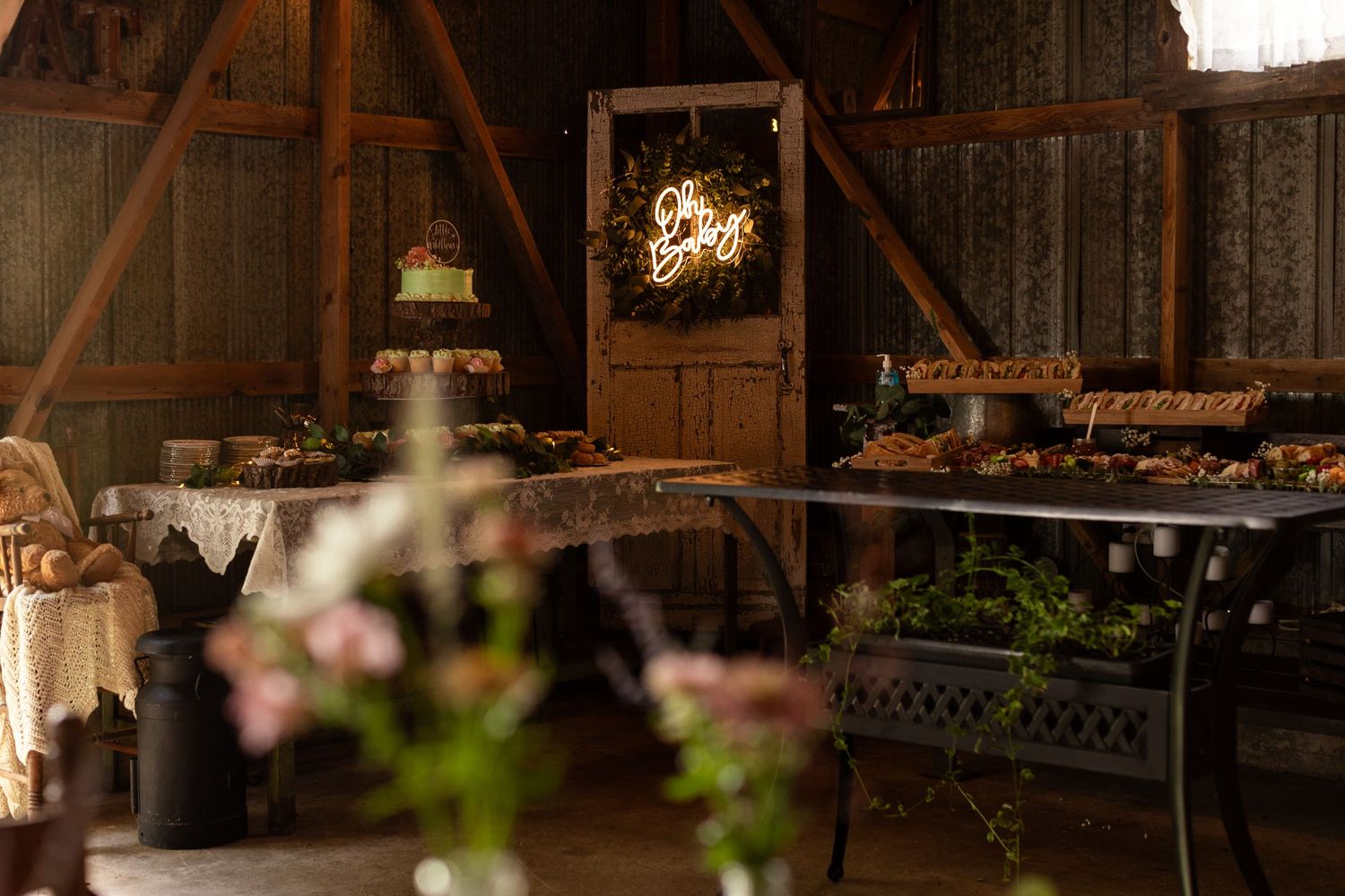 Rustic barn wedding venue interior with exposed wooden beams and romantic lighting.