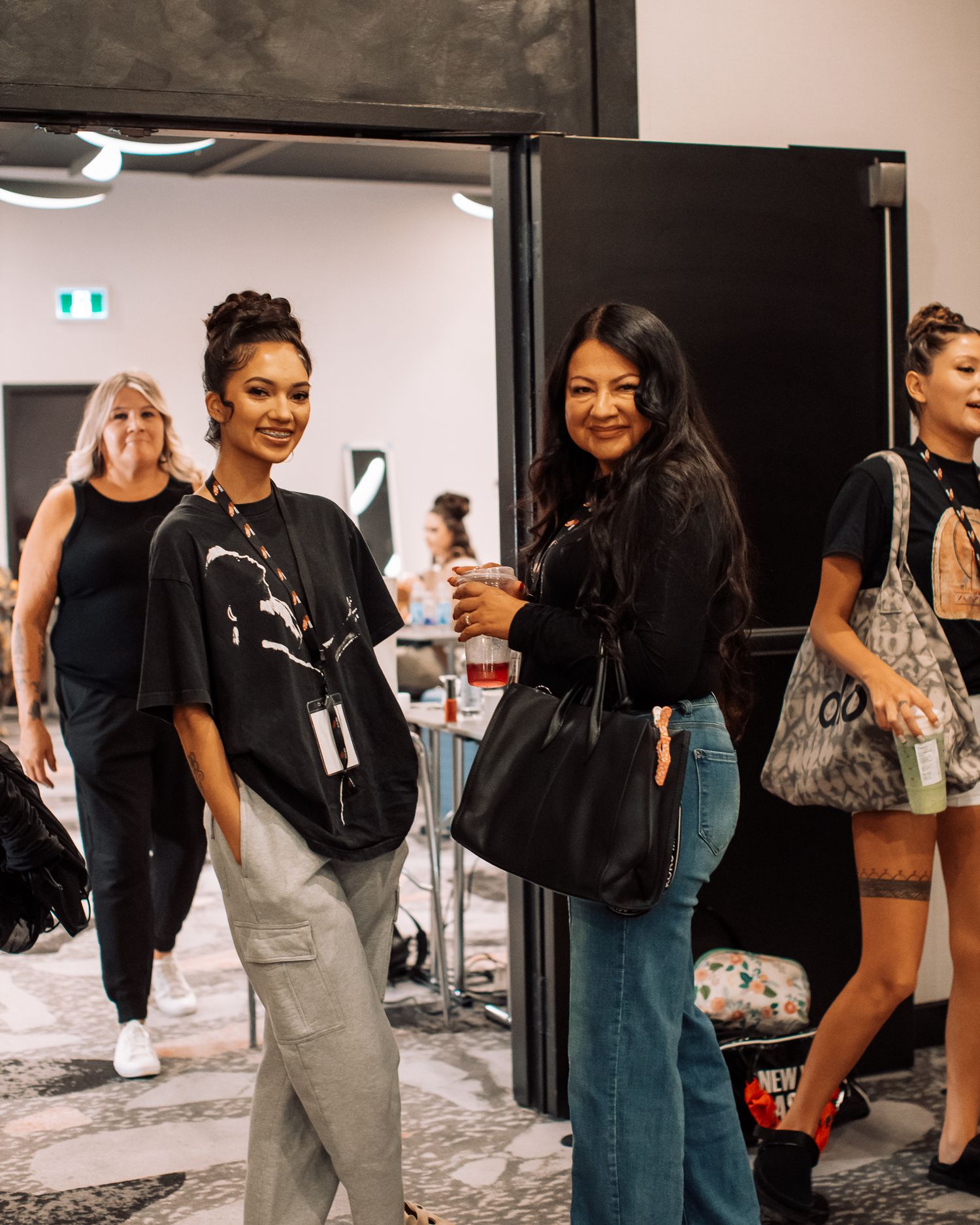 People mingling in a modern white interior space during an event.