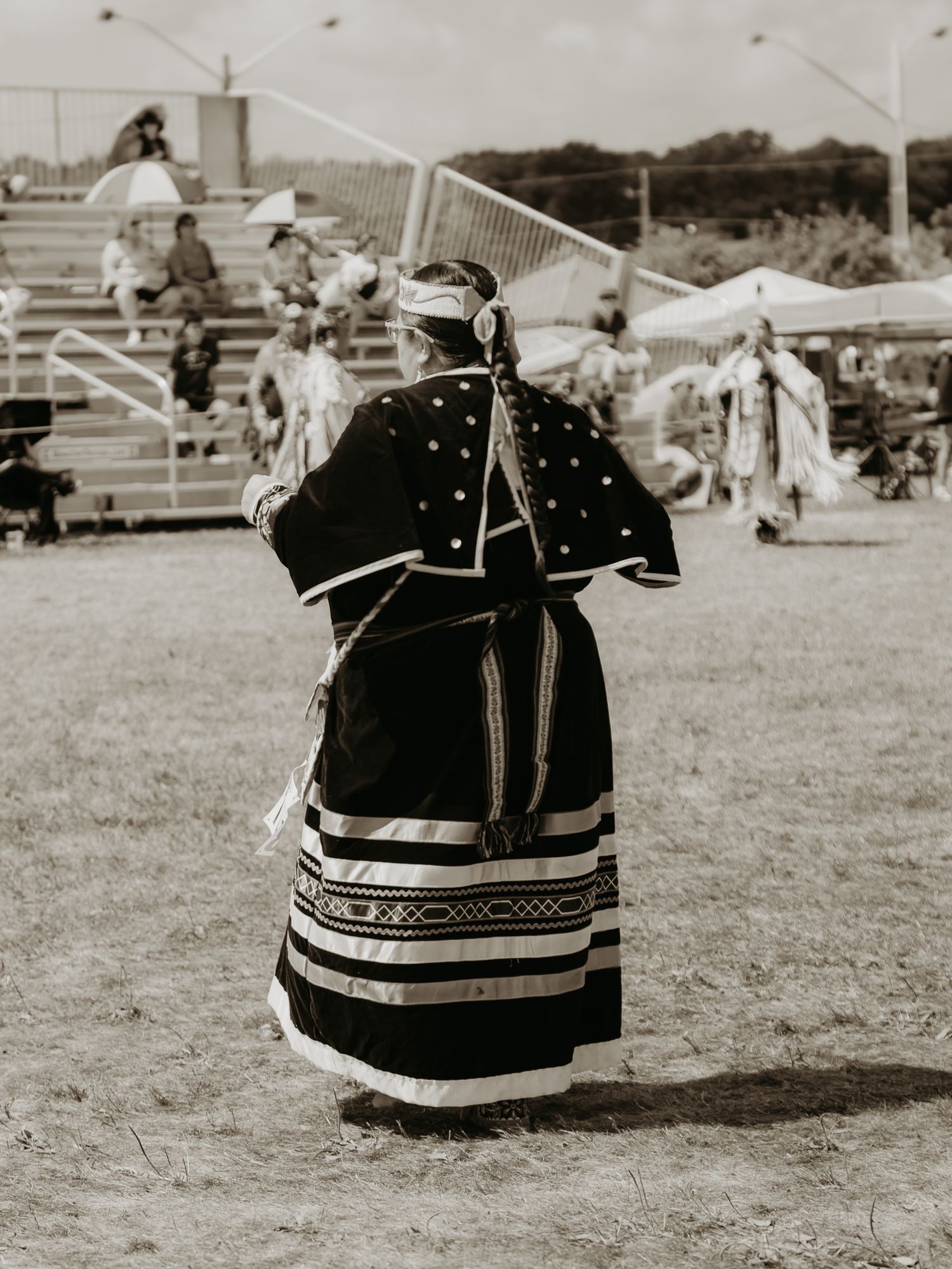 Black and white image of traditional Native American dress skirts with geometric patterns.